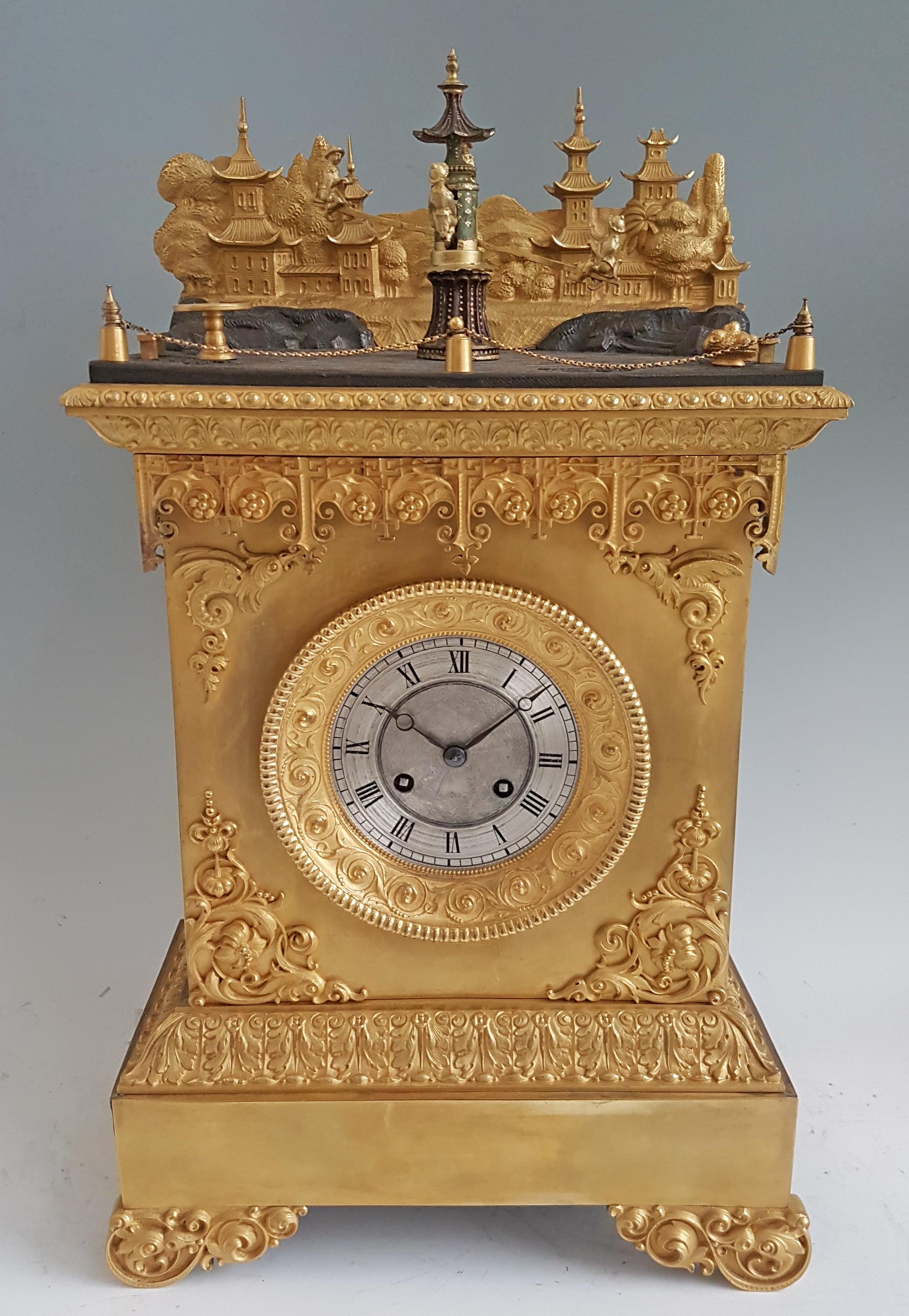 A rare French ormolu chinoiserie automaton mantel clock. The mercury fire gilded ormolu case has elaborate bracket feet to the front, and fine ormolu mounts of anthemion to the front below the dial, whilst above are two very fine mounts depicting