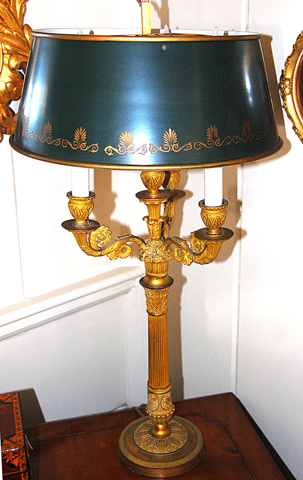 French ormolu three light candelabra with adjustable green tole shade. The Candelabra has been electrified, replacing the candles with flame bulbs. The shade has gold detailing to the lower edge and is adjustable up and down, early to mid-19th