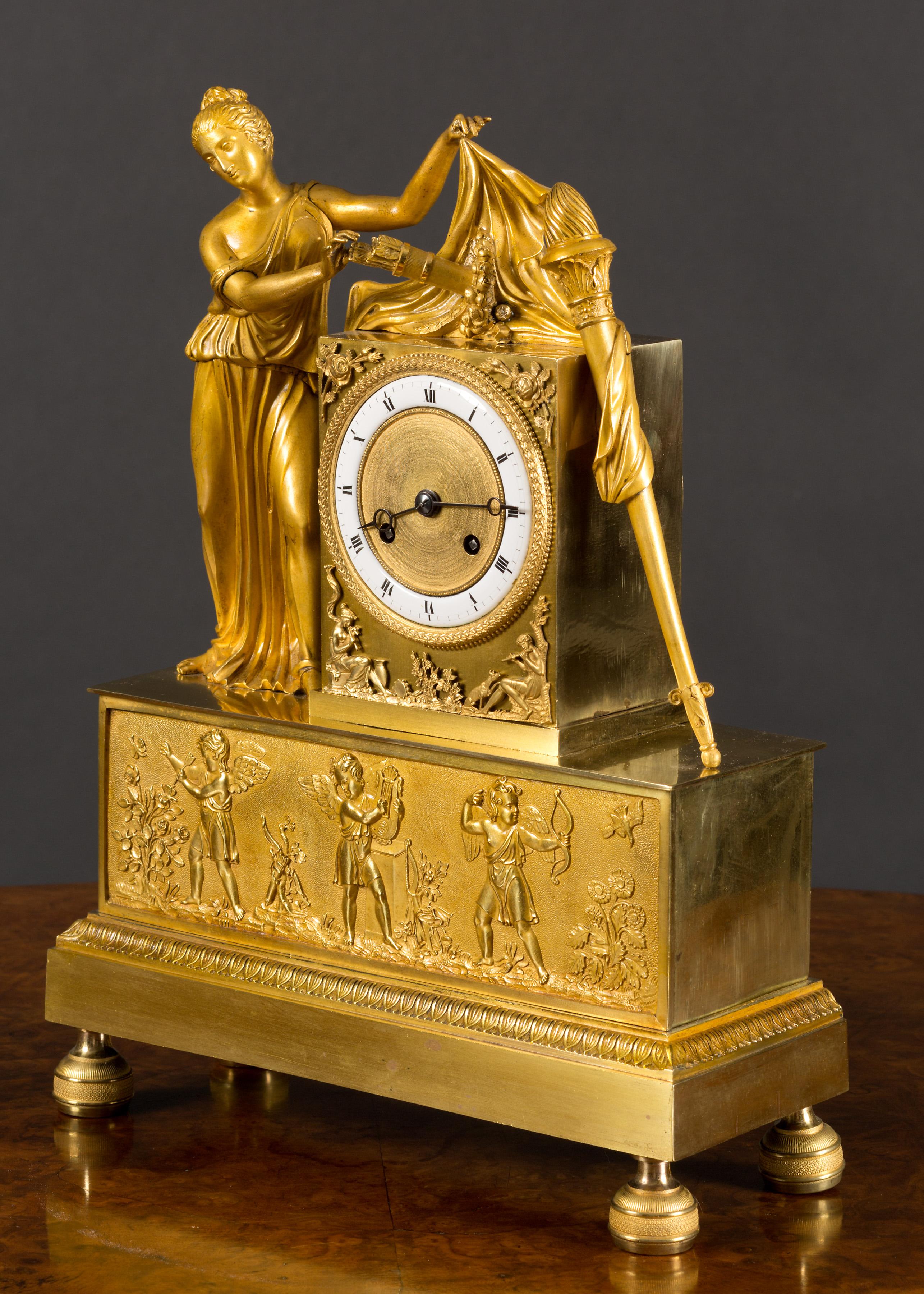 French ormolu mantel clock standing on a stepped base and resting on turned, chased feet with acanthus leaf decoration below a finely chased foliate frieze featuring three cherubs.

Gilded 3 inch dial with enamel chapter ring, Roman numerals and