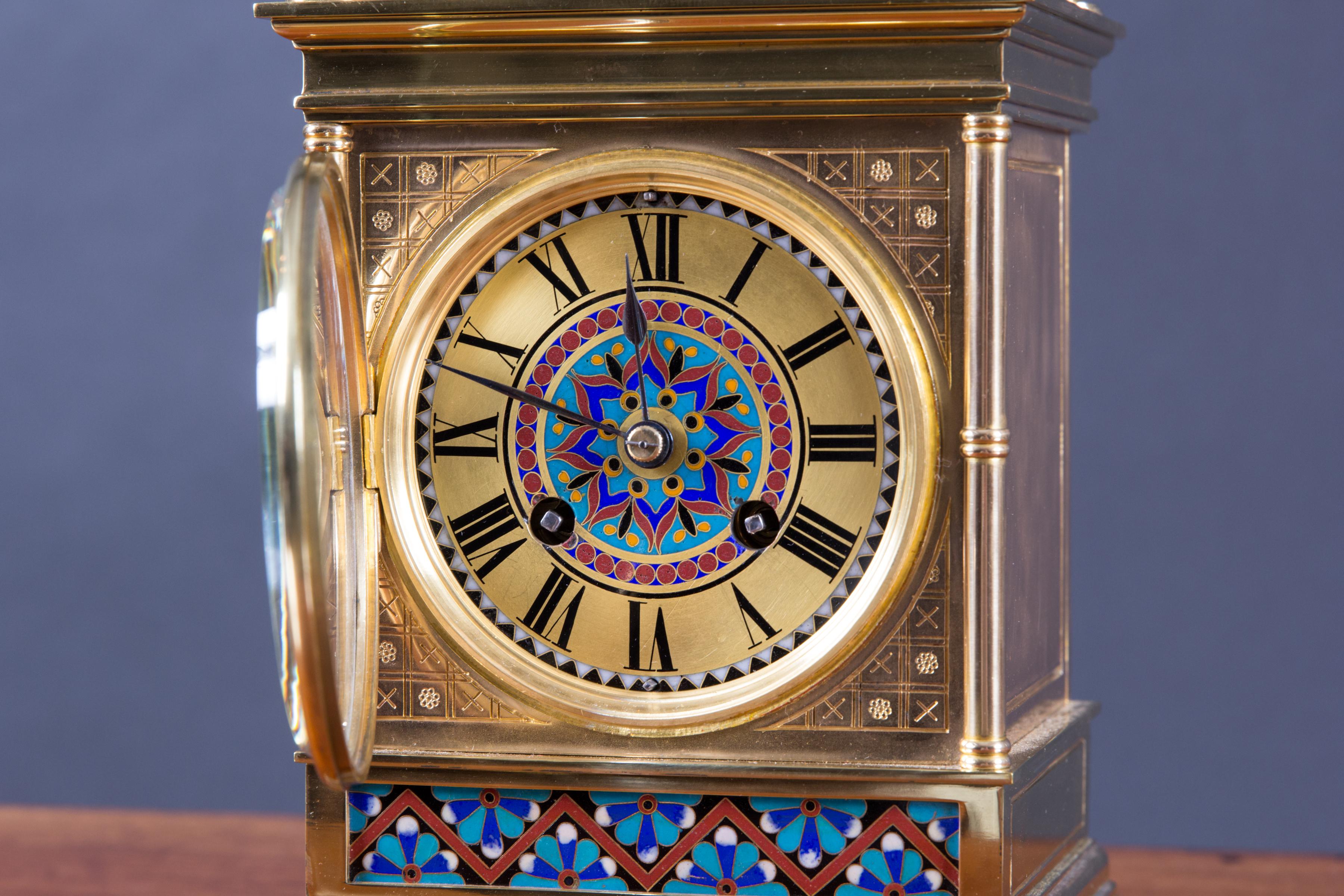 French gilt ormolu mantle clock with beautiful champlevé decoration with turned pilasters, architectural pediment with four turned finials.

Gilded chapter ring with Roman numerals.

Eight day French movement signed ‘Japy Freres’ striking the