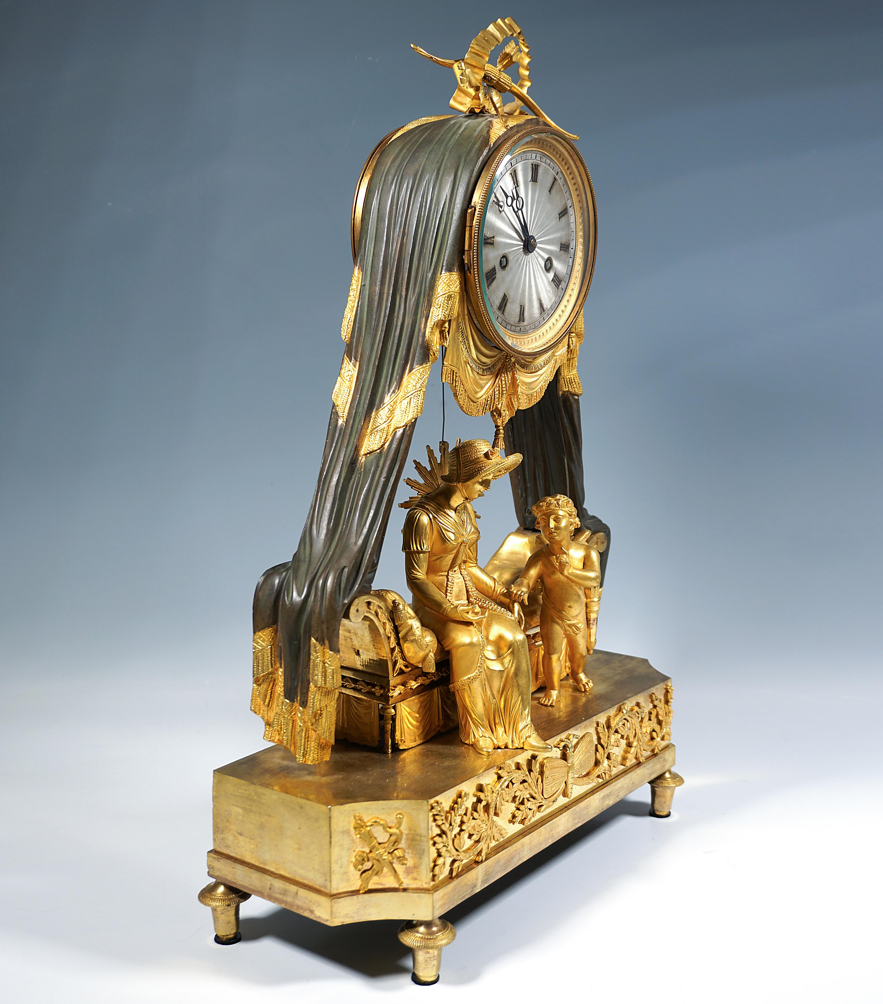 Excellent fire-gilded Empire bronze mantel clock: structure in the form of a rectangular, stepped pedestal that tapers at the front corners, on four spindle feet, with relief ornaments appliquéd on the front of the pedestal, featuring a