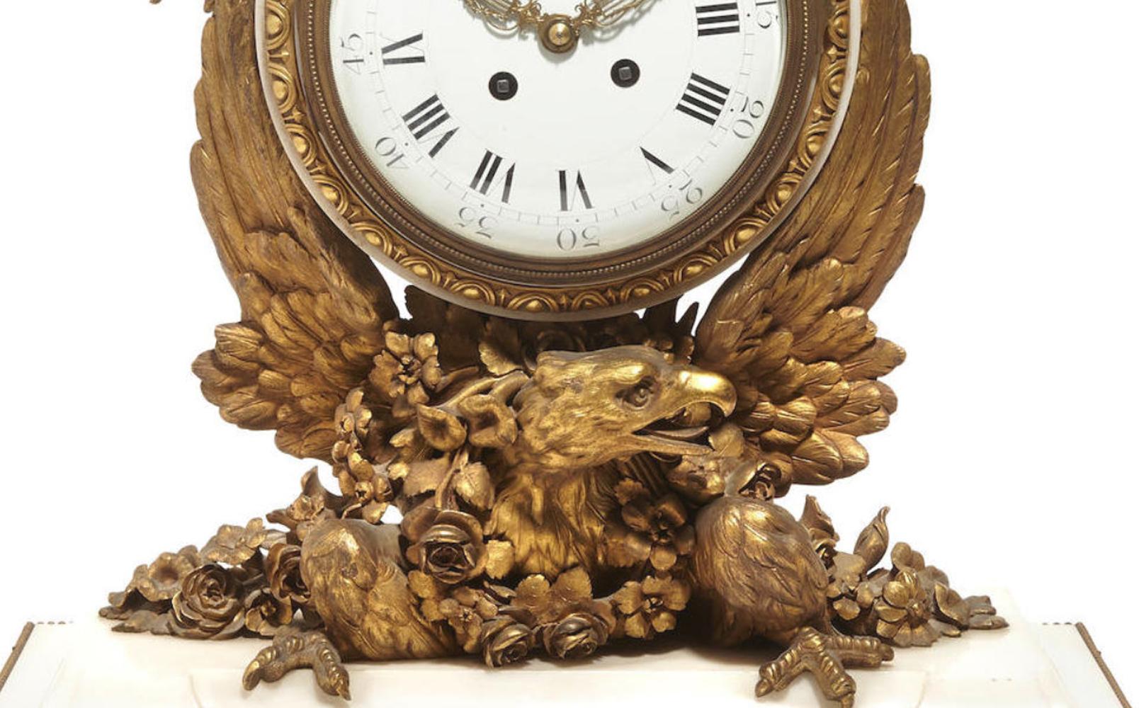 Spectacular and unique French Napoleon III ormolu mounted white marble mantel clock, 19th century.

The clock is surmounted by a gilt bronze pineapple finial with ribbons over a porcelain clock face with Roman Numerals enclosed into an ormolu egg