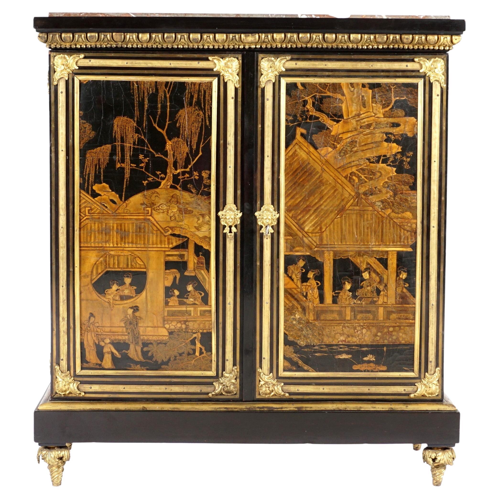 A French Ormolu mounted and brass inlaid ebonized and chinese lacquer cabinet or MEUBLE D'APPUI. Inset marble top over black lacquered case, ormolu gadroon border and decoration. A pair of cabinet doors opening to a shelved interior with two