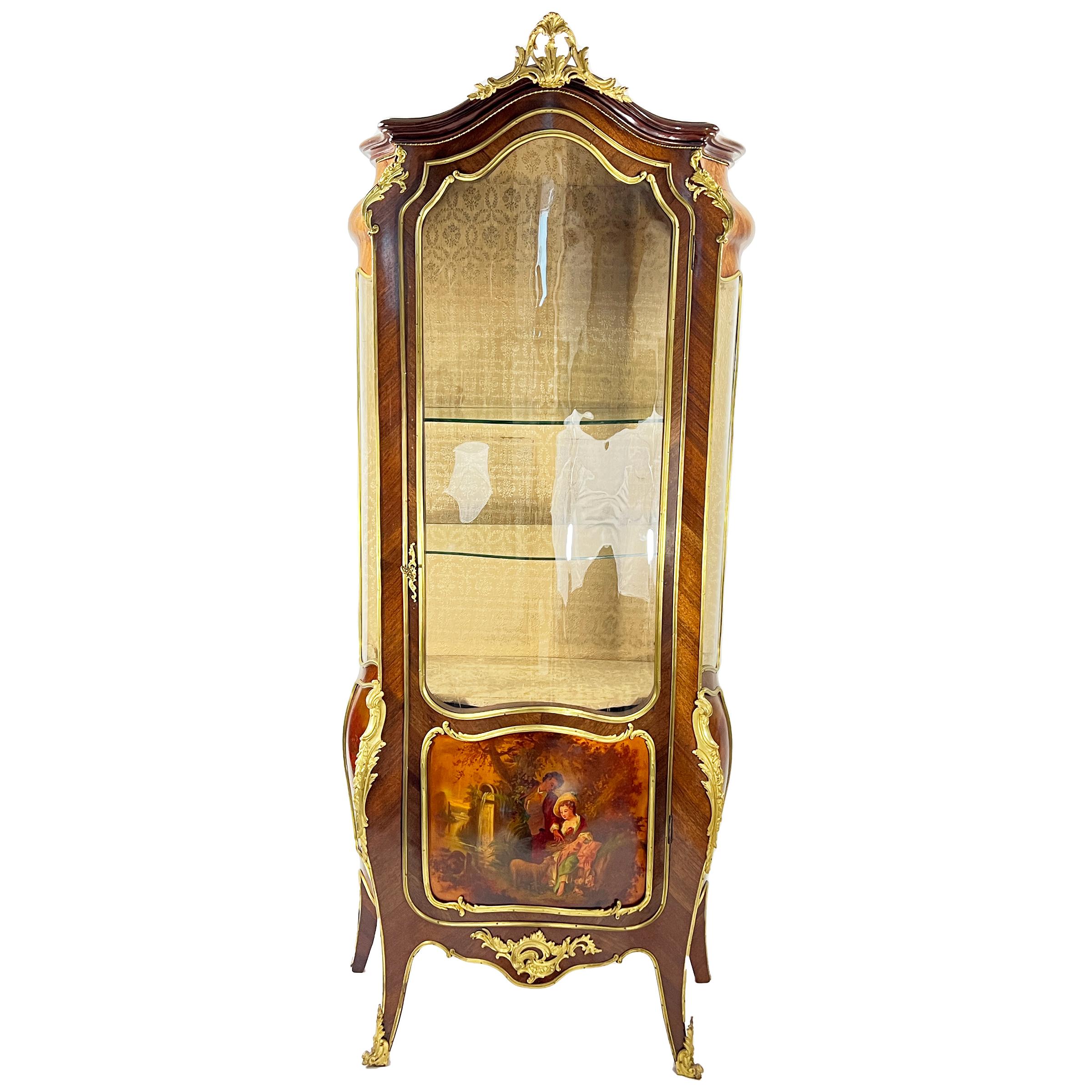 A fine late 19th century French vitrine cabinet, single glazed door, two glass shelves and lower storage. The front panel painted with lovers and landscape scenes on the sides.