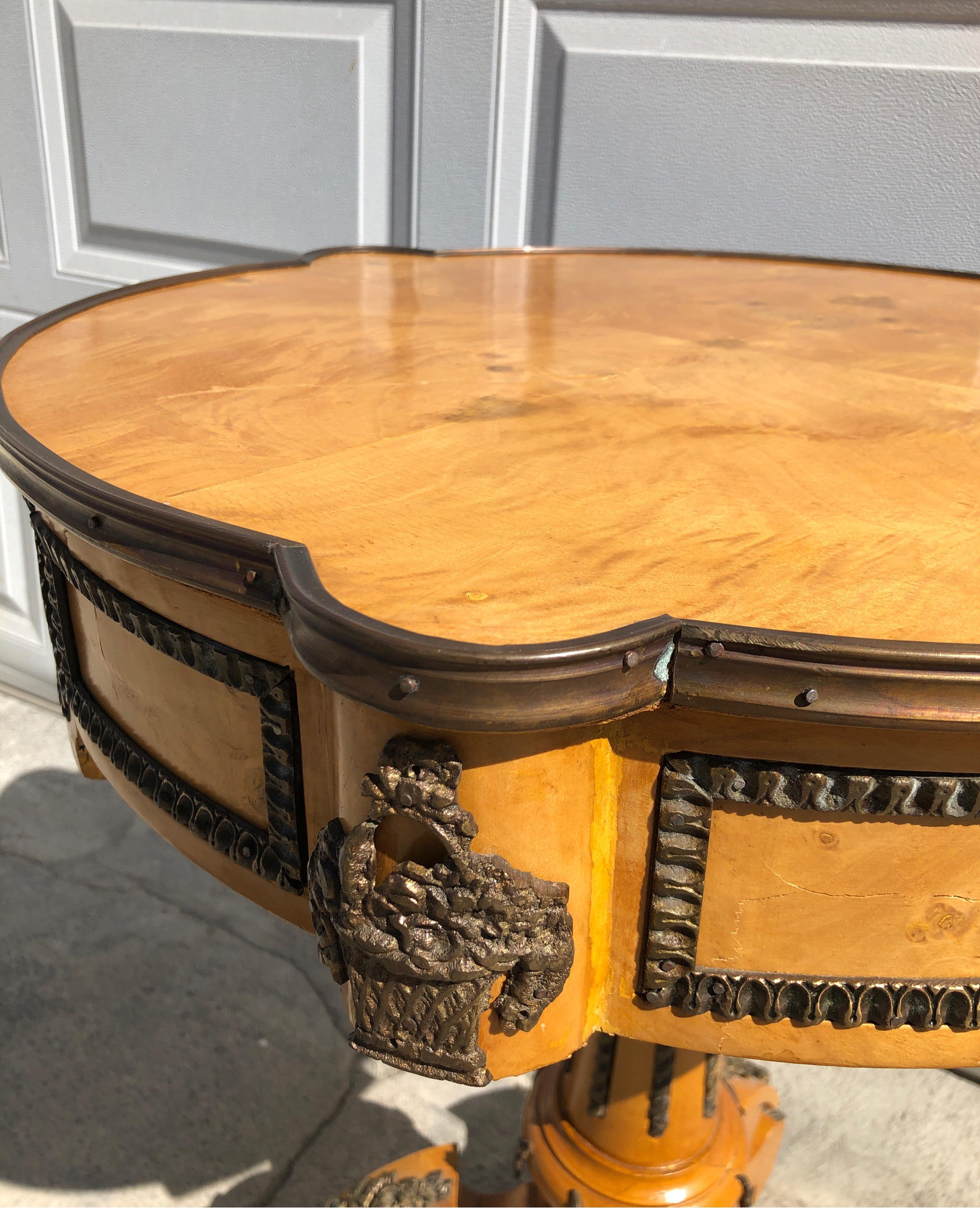 Unique highly decorative French occasional table/center table on pedestal with brass ormolu mounts.
Burled birds eye maple wood.

  