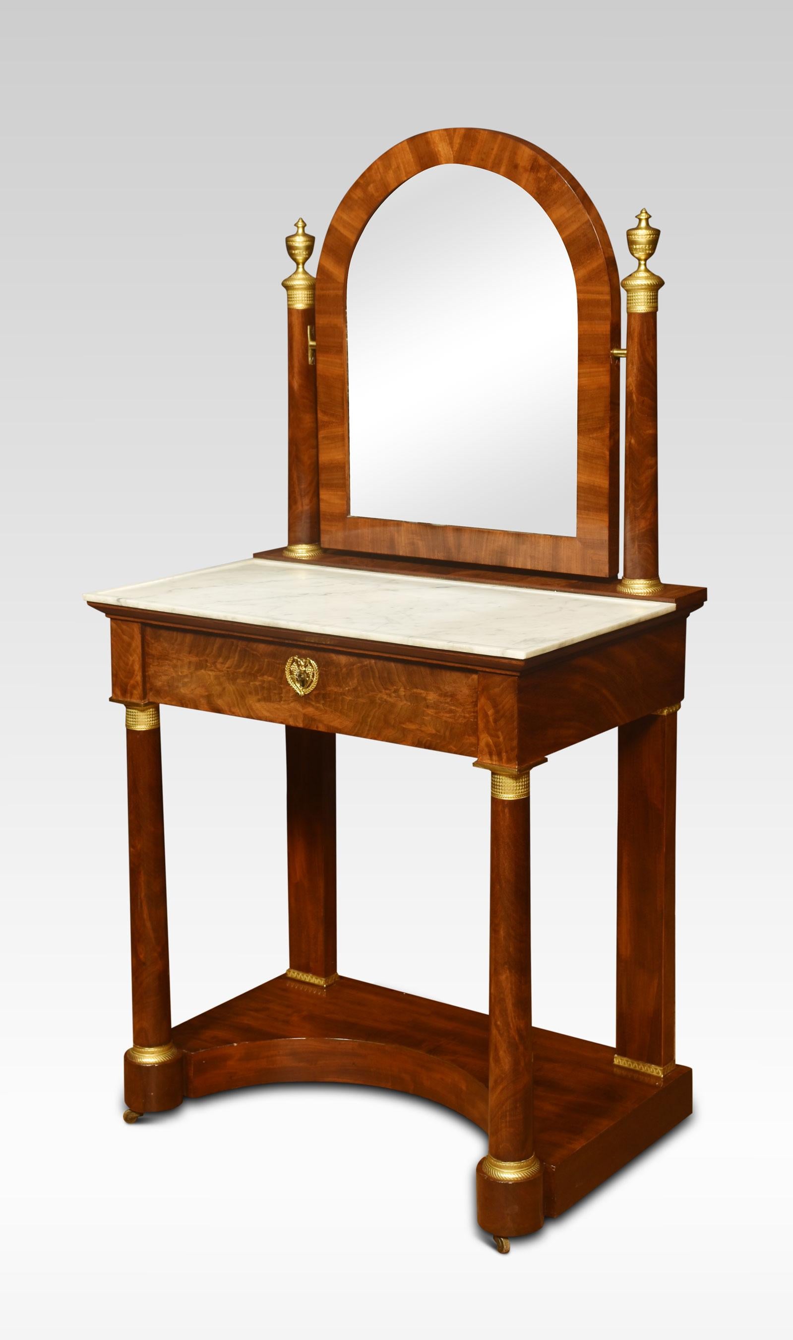 19th-century French Empire dressing table. The upright supports of cylindrical form, flanking the original oval mirror plate. The base section having an inset marble top over a large freeze drawer. All raised up on cylindrical supports united by