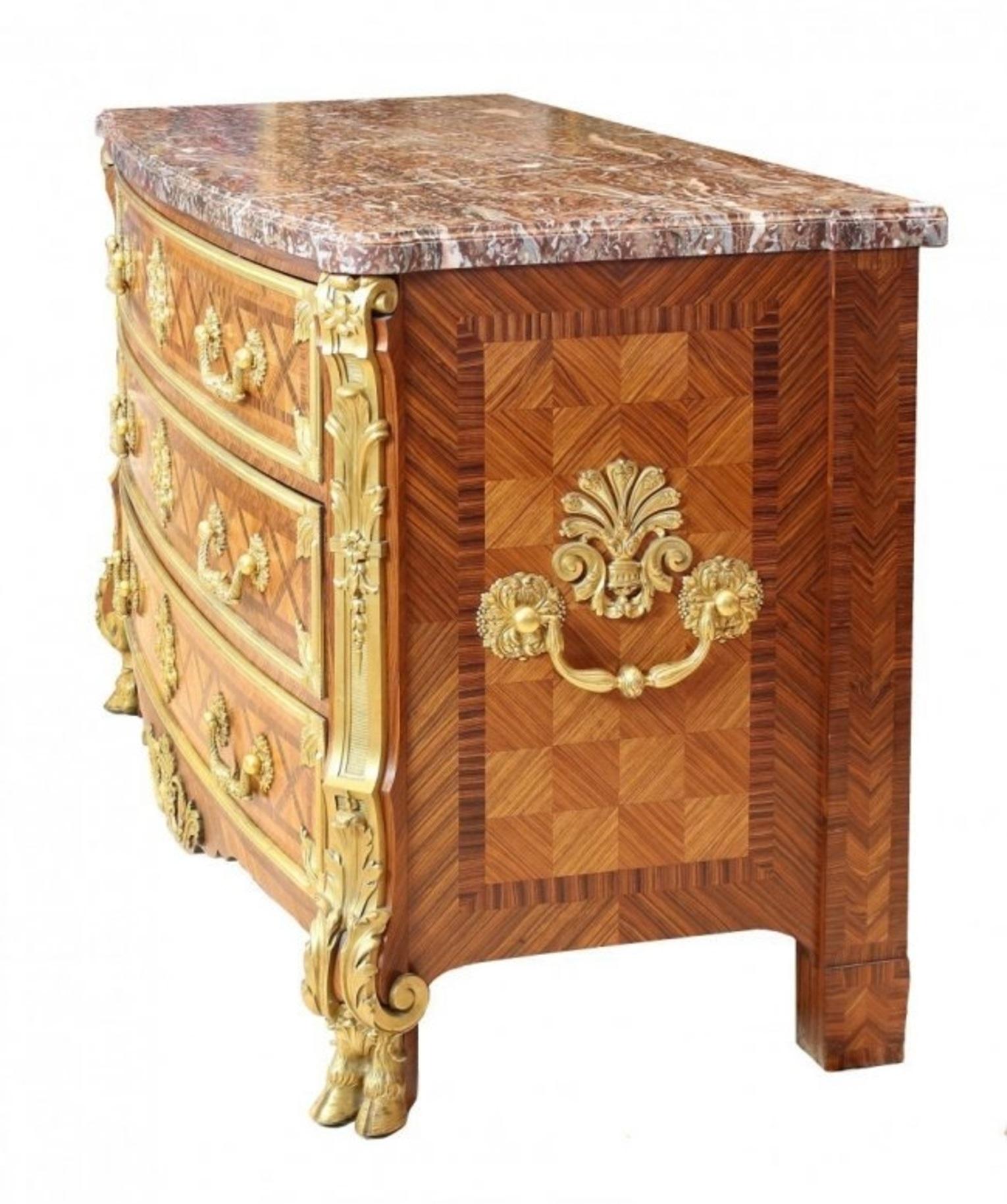 A French ormolu-mounted mahogany and tulipwood parquetry commode
After the model by Jean-Francois Leleu,
By Paul Sormani, Paris, last quarter 19th century
The 'D'-shaped Sarrancolin marble top above a trailing vine and acanthus frieze fitted with