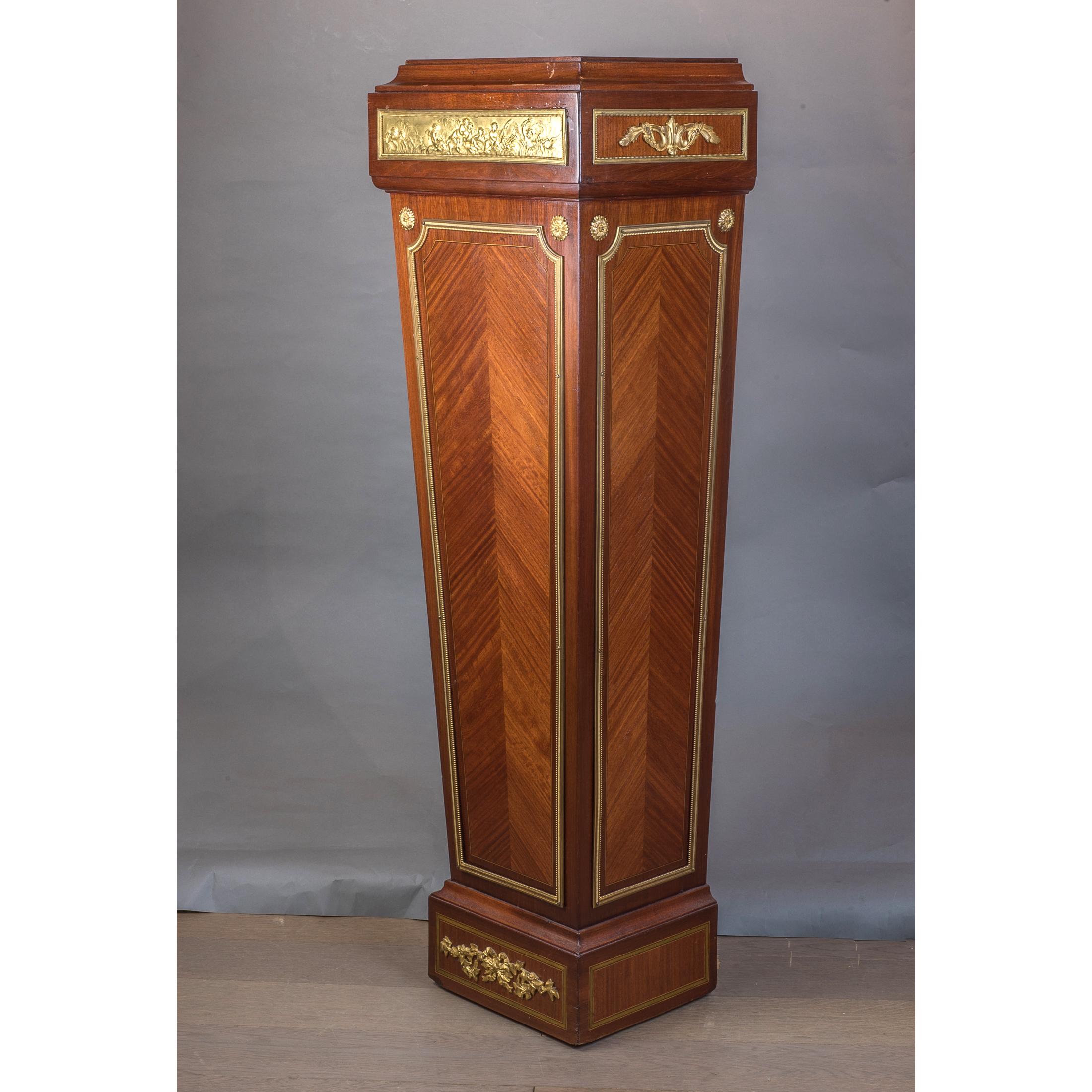 Gorgeous Mahogany wood pedestals with guilt bronze ornamentation. Rectangular golden plaques depicting cherubs playing instruments and relaxing in the clouds decorate the front face of the pedestal. 

Origin: French
Date: 19th century
Dimension: