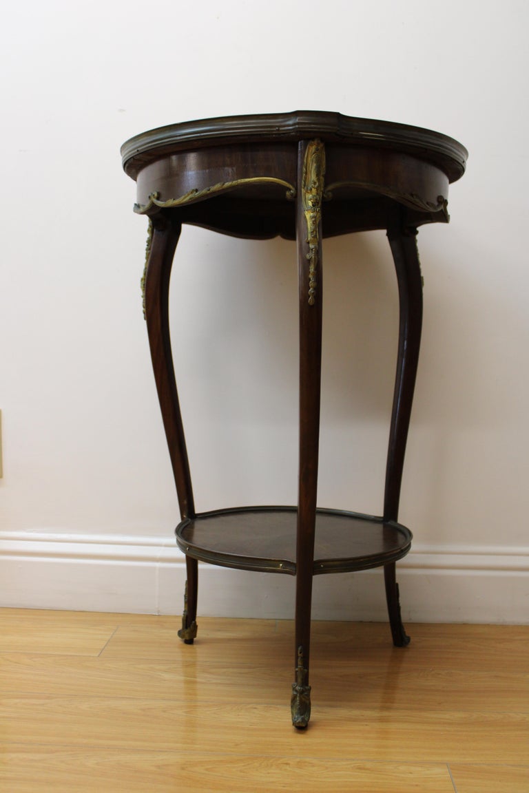 C. 20th century

Beautiful French ormolu mounted marble topside end table ( marble is removeable / can be taken apart ) 
One of the foots brass mount is slightly different than the others.

Dimensions without marble piece: 21.50 W / 21.50 D /