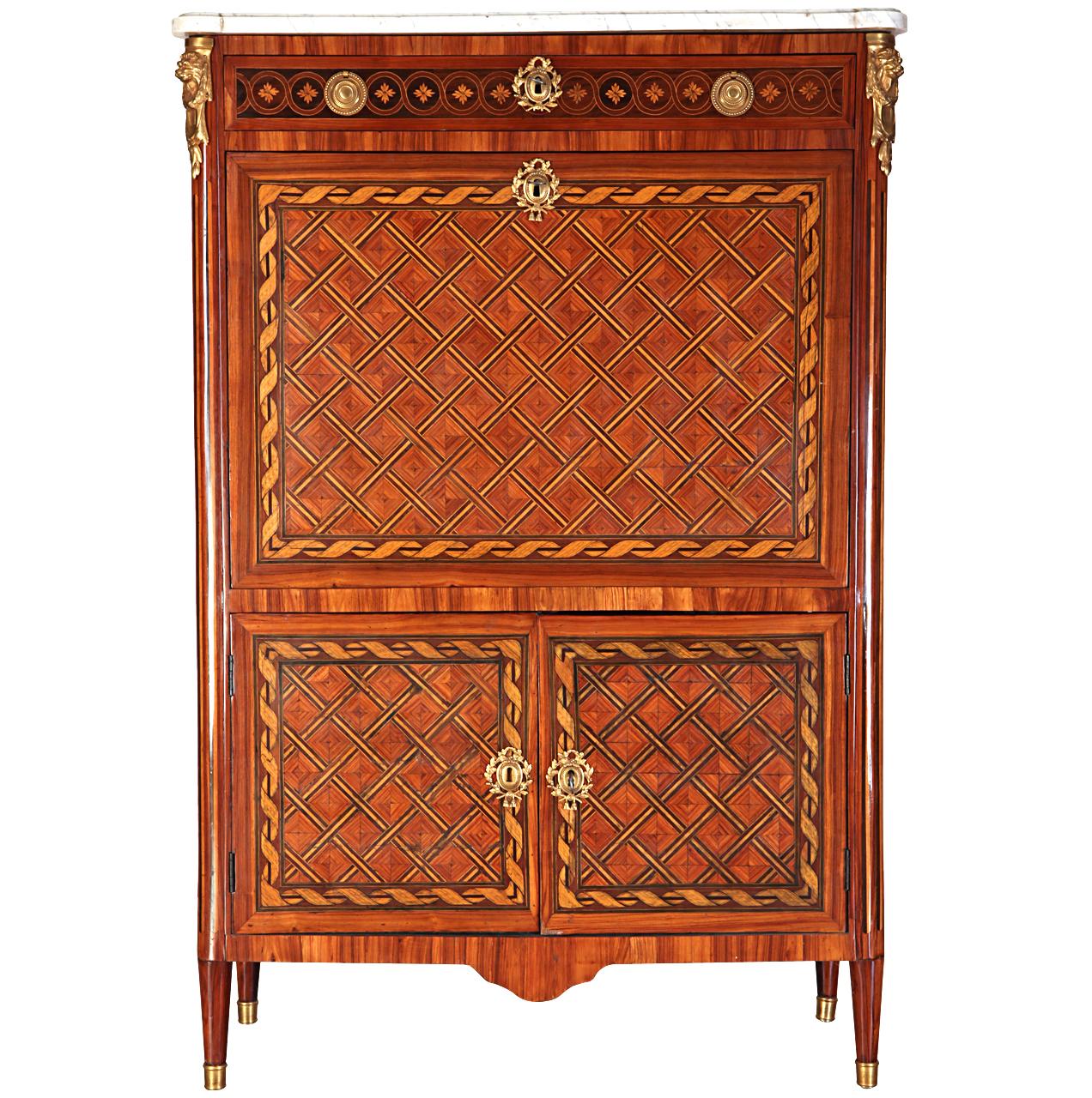 Important French ormolu-mounted, kingwood, tulipwood and stained sycamore marqueterie and parquetry secretaire abattant with rectangular moulded white marble top, above a frieze drawer inlaid with flower heads, fall front enclosing a leather-lined