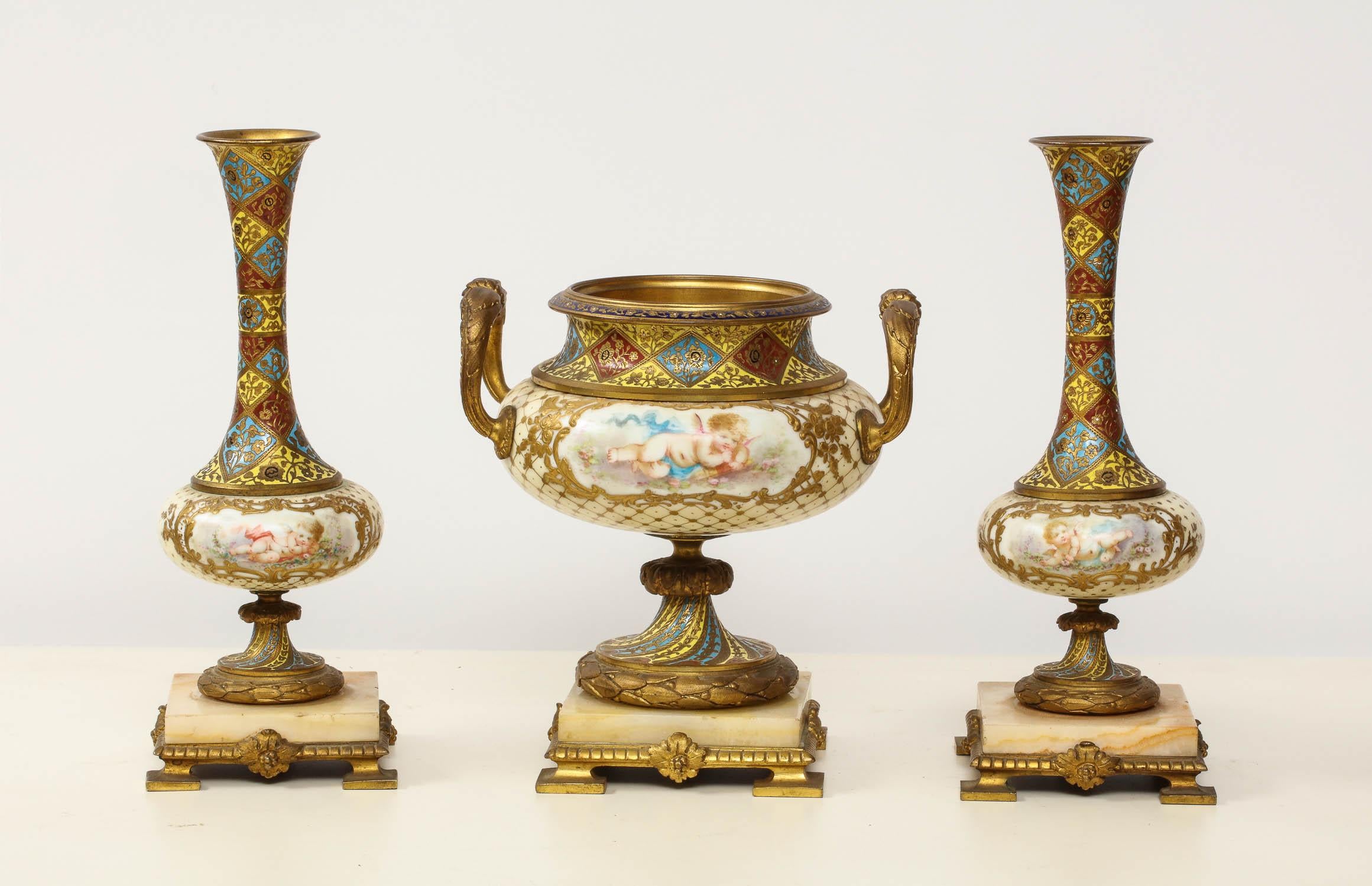 French ormolu-mounted Sevres style porcelain, Champlevé enamel, and onyx garniture, comprising of a pair of vases and centerpiece,

circa, 1880

Nice quality throughout. Good condition, ready to place.

Measures: Vases 8