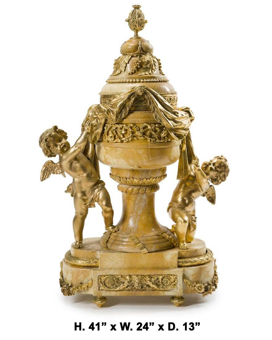 Magnificent French ormolu-mounted Siena marble figural centerpiece.
Late 20th century.

The very impressive and beautifully shaped Sienna marble centerpiece is surmounted with a ormolu fruiting finial, over a carved domed lid decorated in foliate