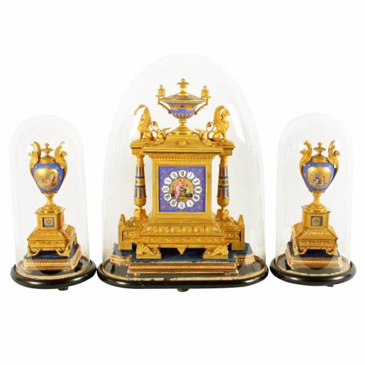 French Ormolu & porcelain clock garniture

A 19th century Napoleon III French Sévres style ormolu and porcelain three piece clock garniture.

The clock and side ornaments sit on velvet and gilt wood plinths which in turn sit on ebonised plinths