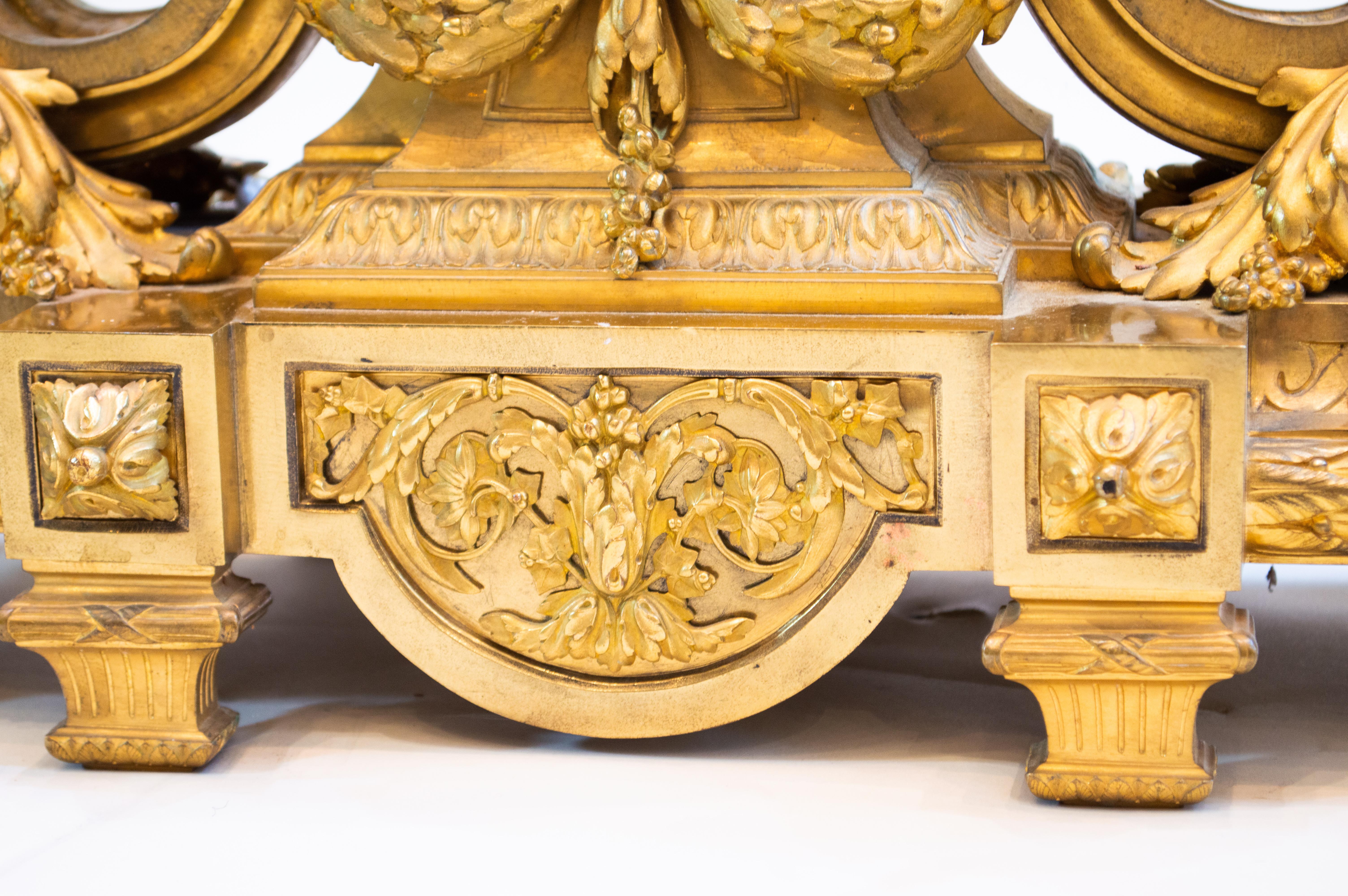 French ormolu three-piece clock garniture
Comprising a mantel clock and a pair of seven-light candelabra; the clock surmounted by a festooned vase above a circular dial signed F. Barbedienne / a Paris, on volute supports
Measures: clock 57 x