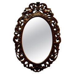 French Ornate Carved Oval Mirror, Decorated with Cherubs