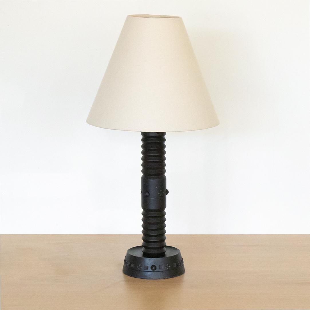 Vintage French dark wood table lamp with ornate decorative design. Original wood finish with signs of wear and age. Newly re-wired and new linen shade.