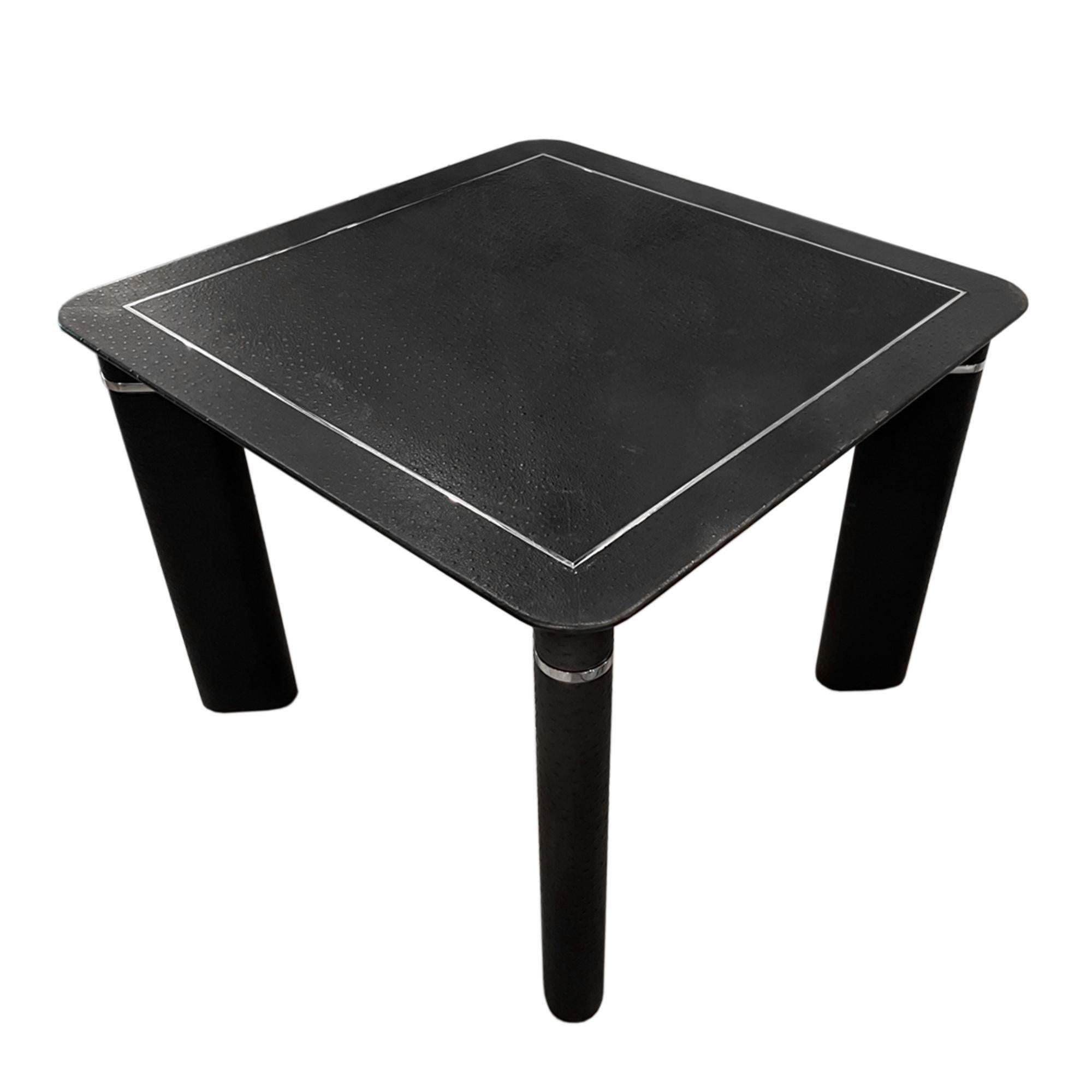 This super stylish card table was made in France in the 1970s.

Covered ostrich skin with chrome trim and retractable drinks holders. 

Perfect for games' nights and parties!
