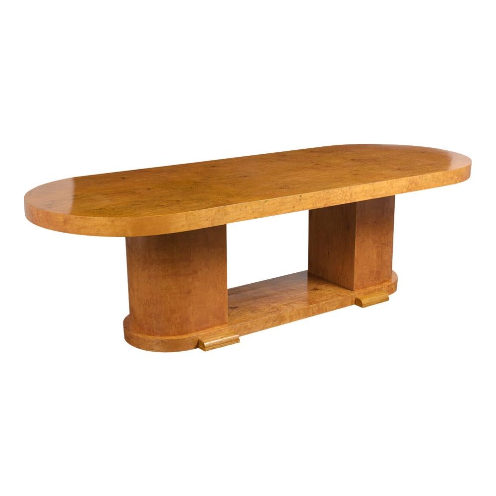 This Modern French Art Deco Burled Dining Table has been newly restored and has a new natural color lacquered finish. The table has a large race track top and also has amazing burled details throughout the table in great condition. This table also