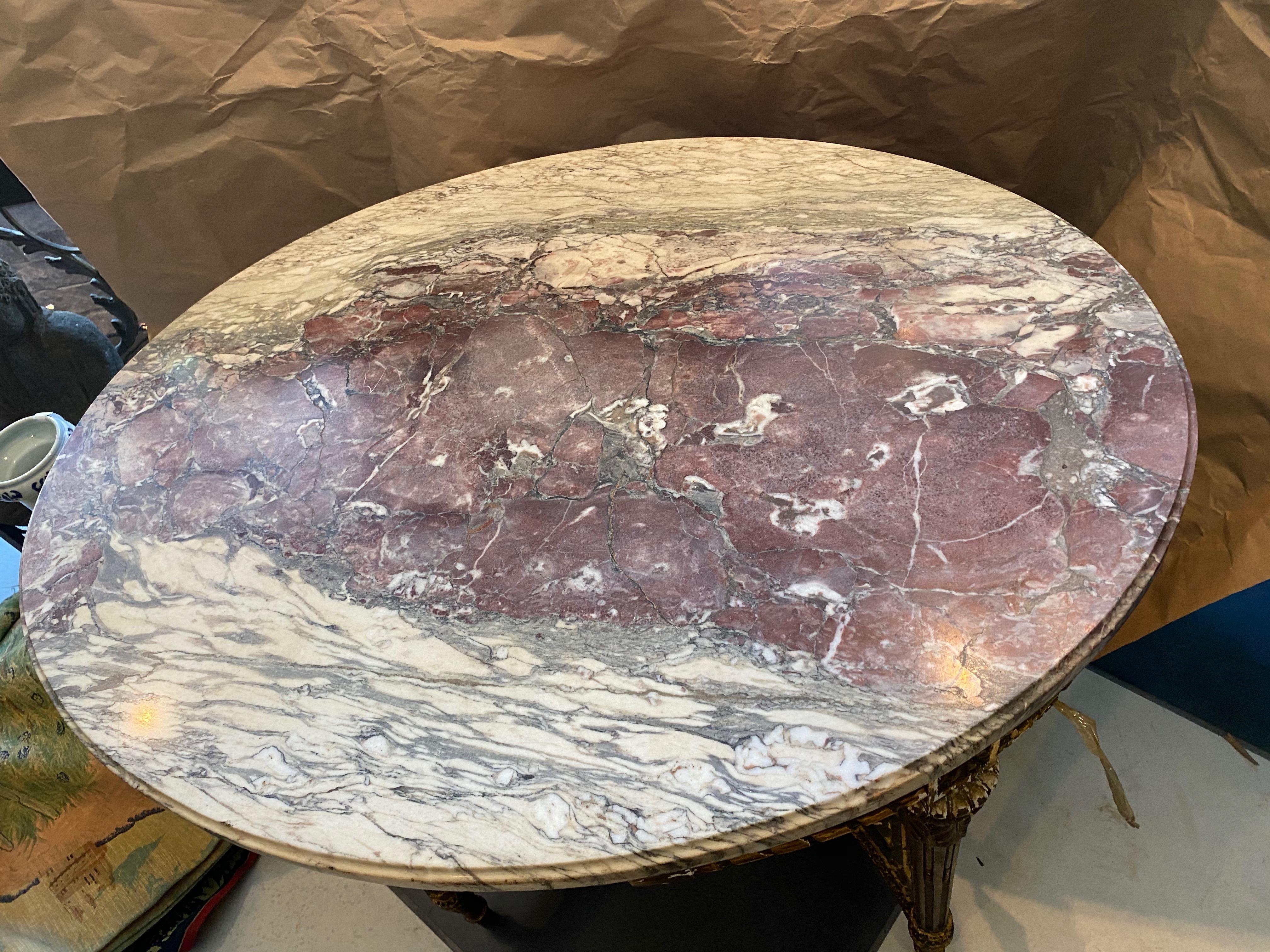This French oval gold leaf round center table has a 