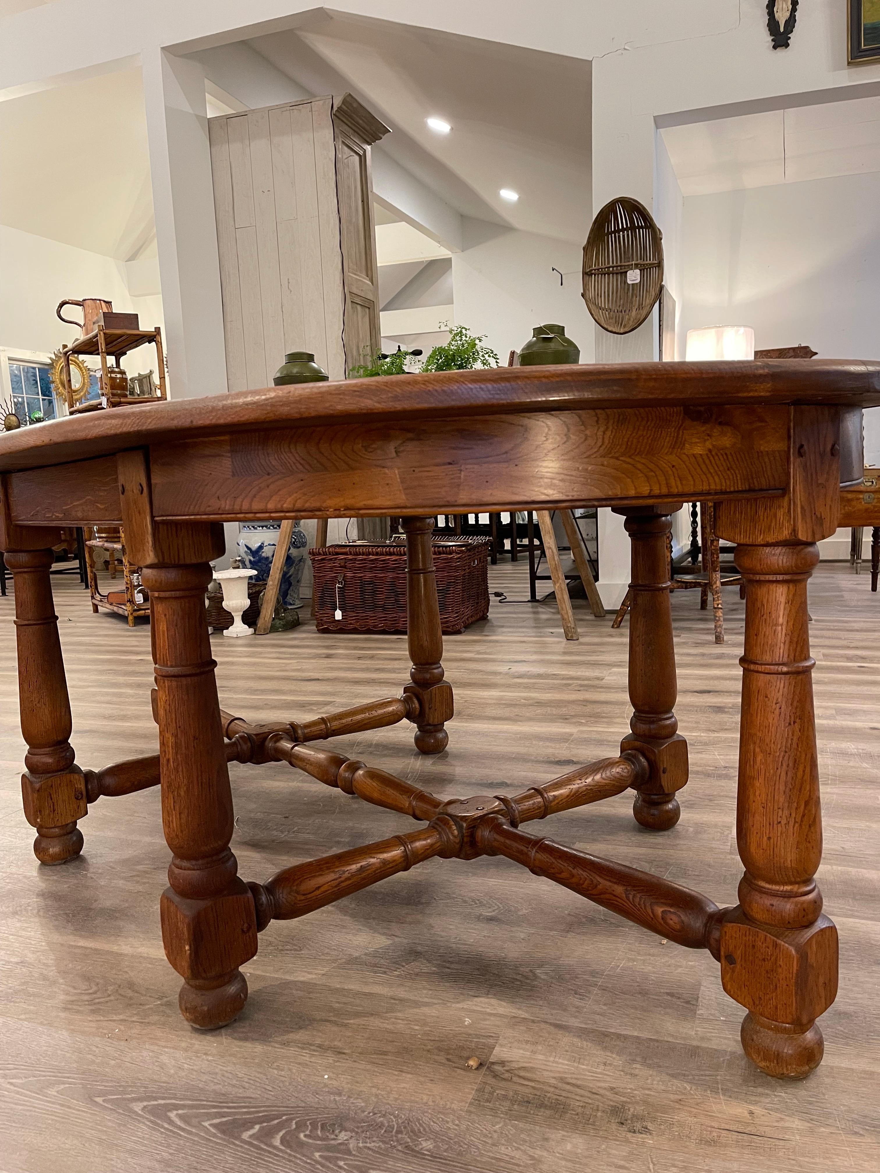 This is a gorgeous antique French dining table! The oval shape of this piece is very unique, as it is not a common design among antique tables. The way the wood was pieced together makes for a beautiful design in the top with long triangular pieces