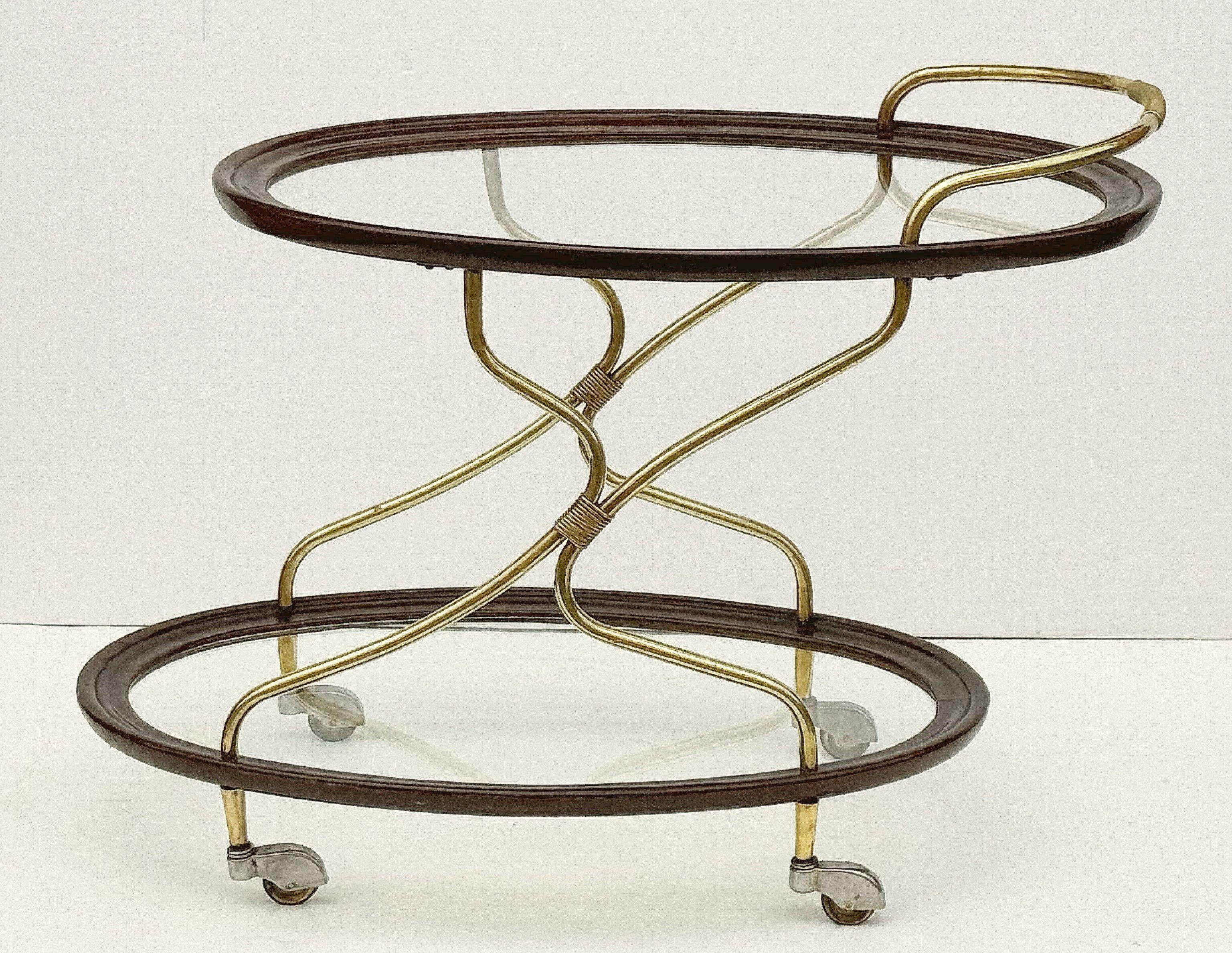 Mid-Century moderno Carrello ovale francese di mogano, ottone e vetro su rotelle in vendita