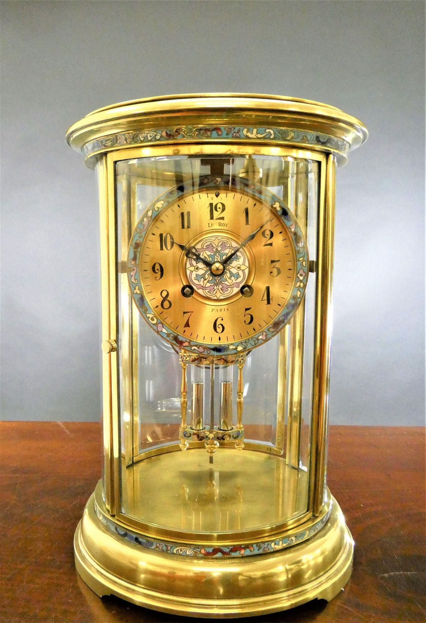 Oval champleve decorated four glass mantel clock.
 
French four glass mantel clock housed in a brass oval shaped case with sky blue champleve enamel decoration. Heavy curved and bevelled glasses to all sides with opening front and back doors.
