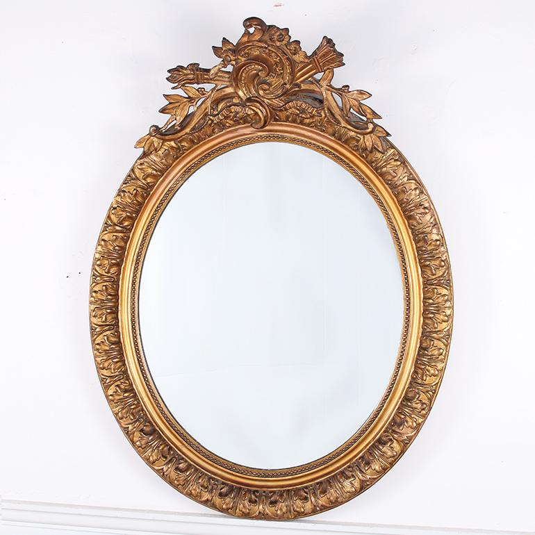 This antique oval mirror retains its original glass with some foxing, as well as the original gilt with and has its original backboards. All in excellent, home-ready condition. Circa 1890.

 