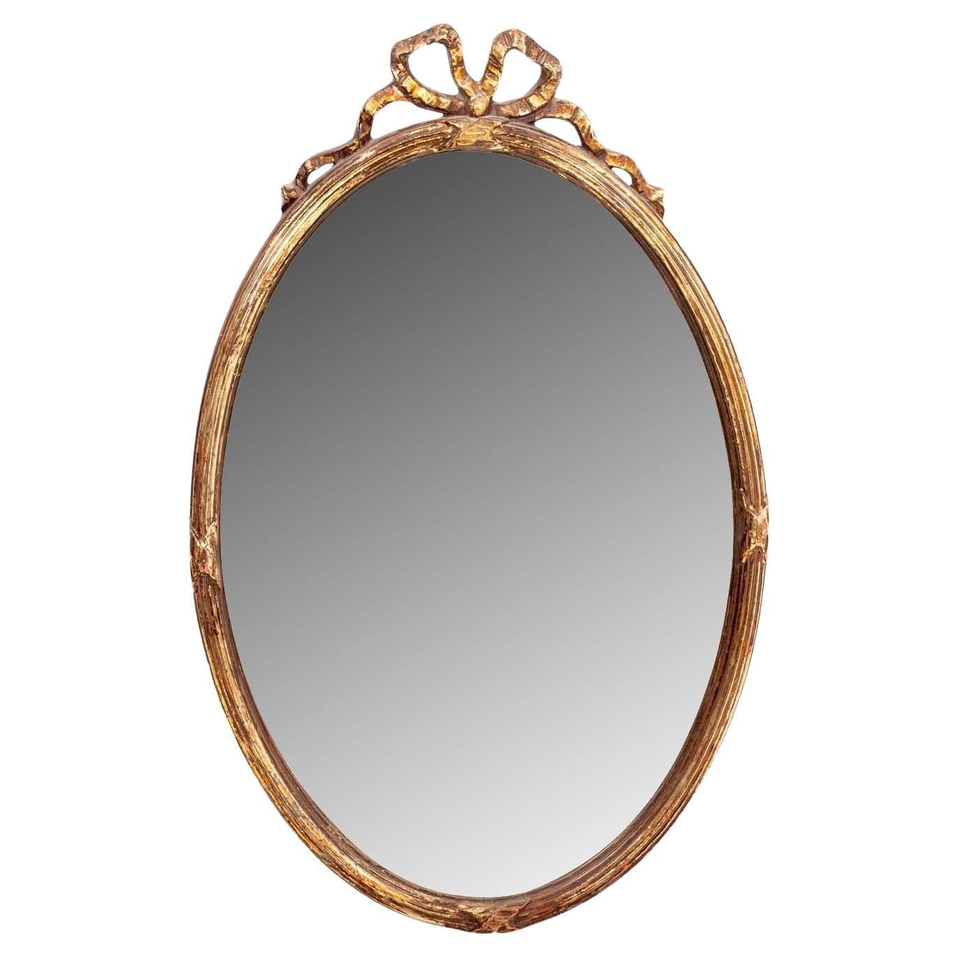 French Oval Gilt Mirror with Bow Crown, Early 20th Century For Sale