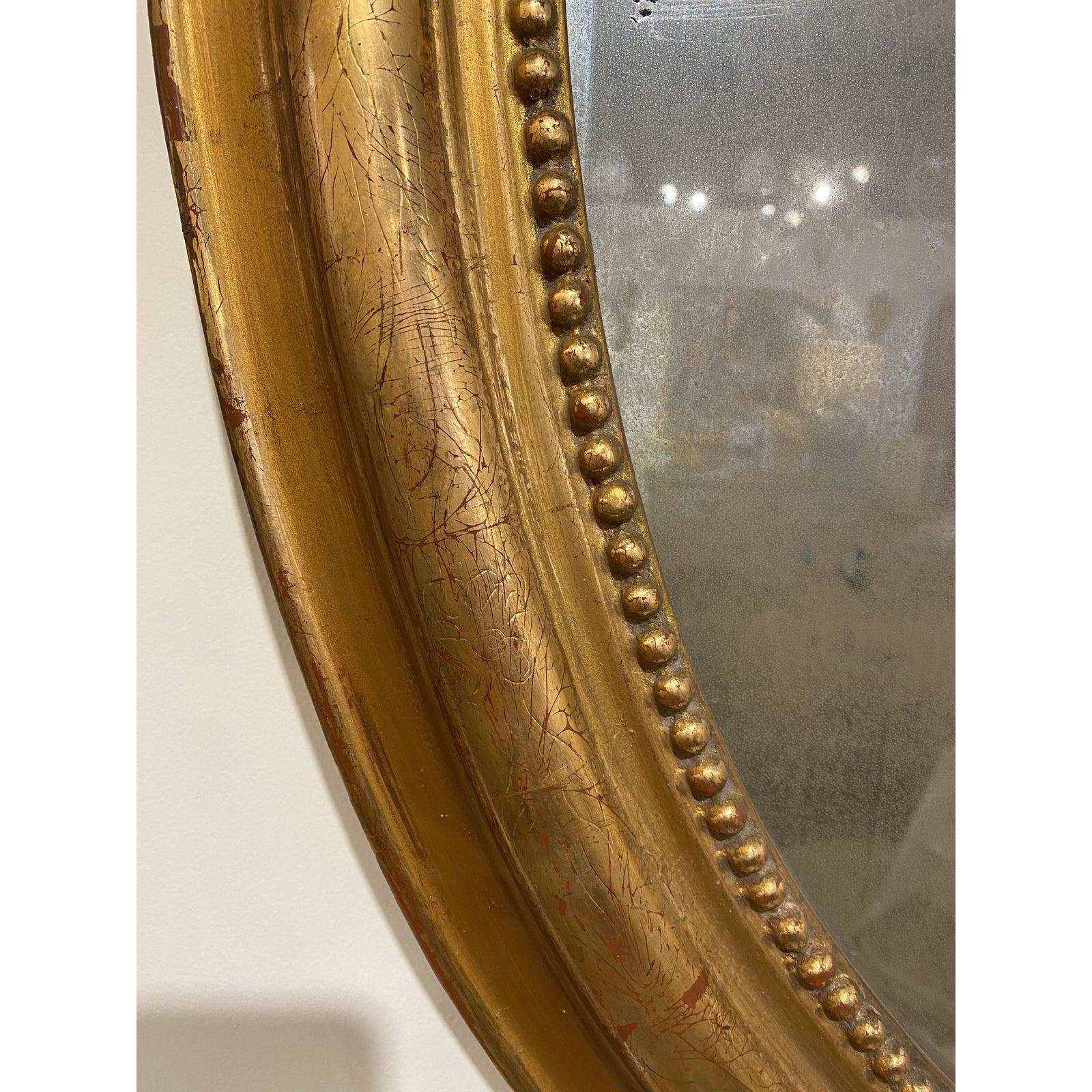 French oval 19th c gilt mirror with carved Laurel leaves. Original mirror. Purchased in Southern France.