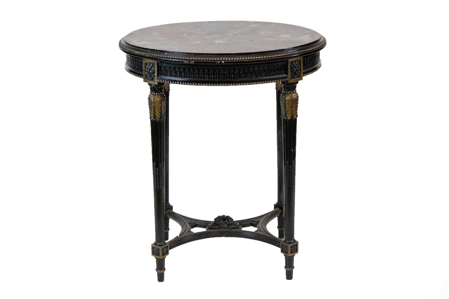 French oval marble top center table, with the top having beaded molding. The apron has carved floral stop fluting and beaded edging. The reeded legs have beaded stop fluting and are braced by a carved quadrafoil concave stretcher.