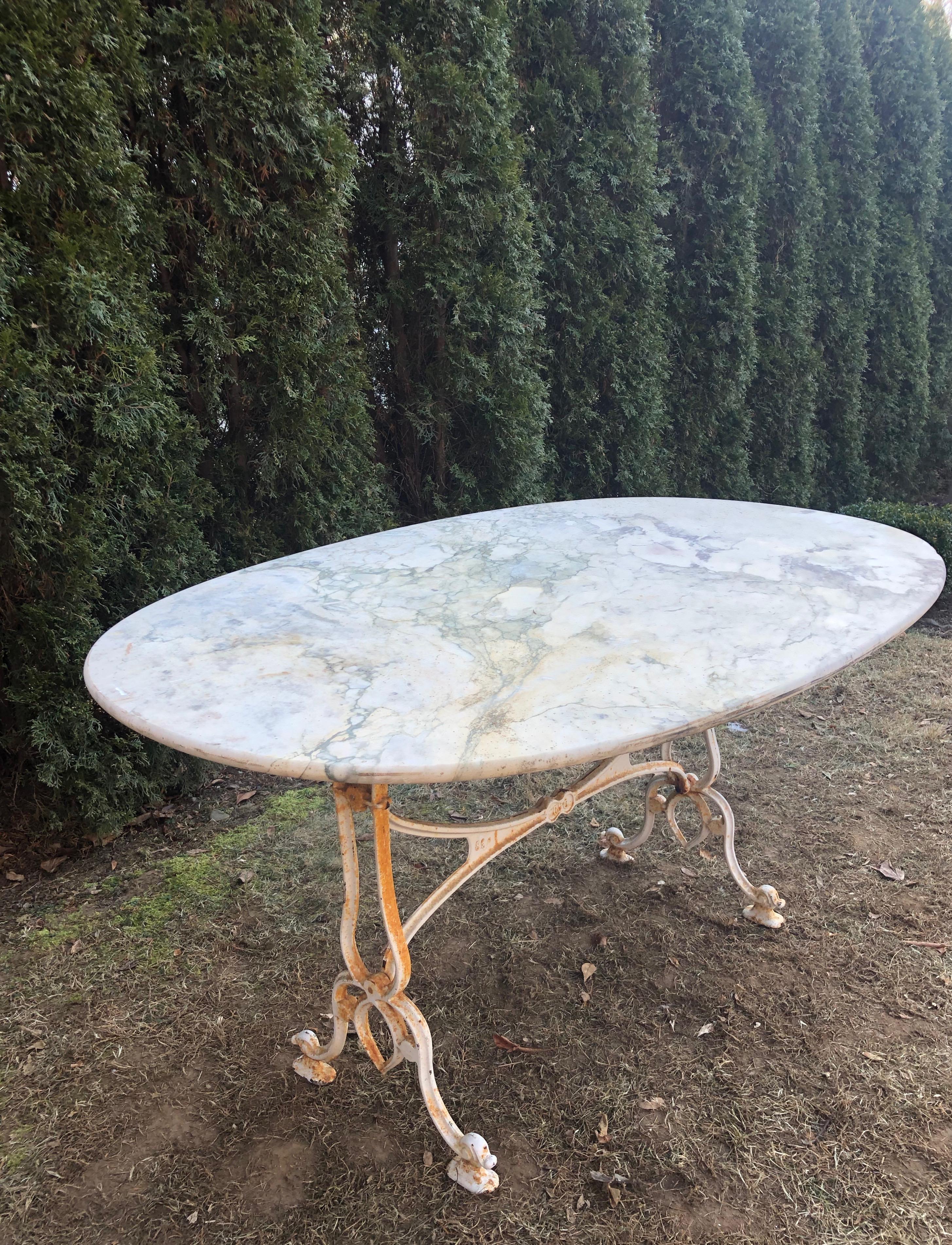 It is rare when we come across oval tables for the garden and this one is a beauty. The top is not a perfect oval, as it was handcut, but lovely nonetheless. The marble reads white with heavy grey veining and is in overall good antique condition,