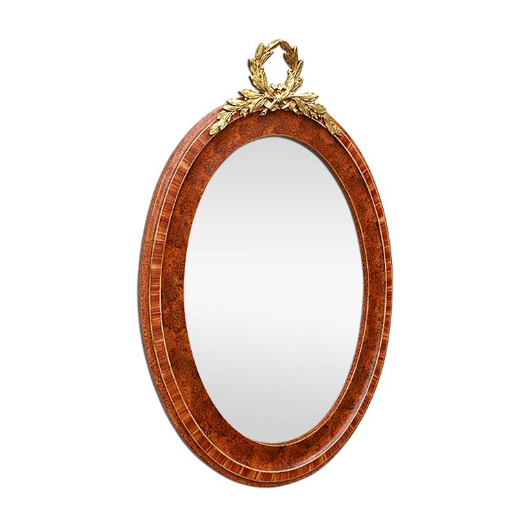 Antique French oval mirror decorated with a pediment in gilded bronze, with a bow of leaves. Painted wooden oval frame, rosewood imitation, painted wood. Antique wood back. Modern glass mirror. Antique frame width: 5.5 cm.