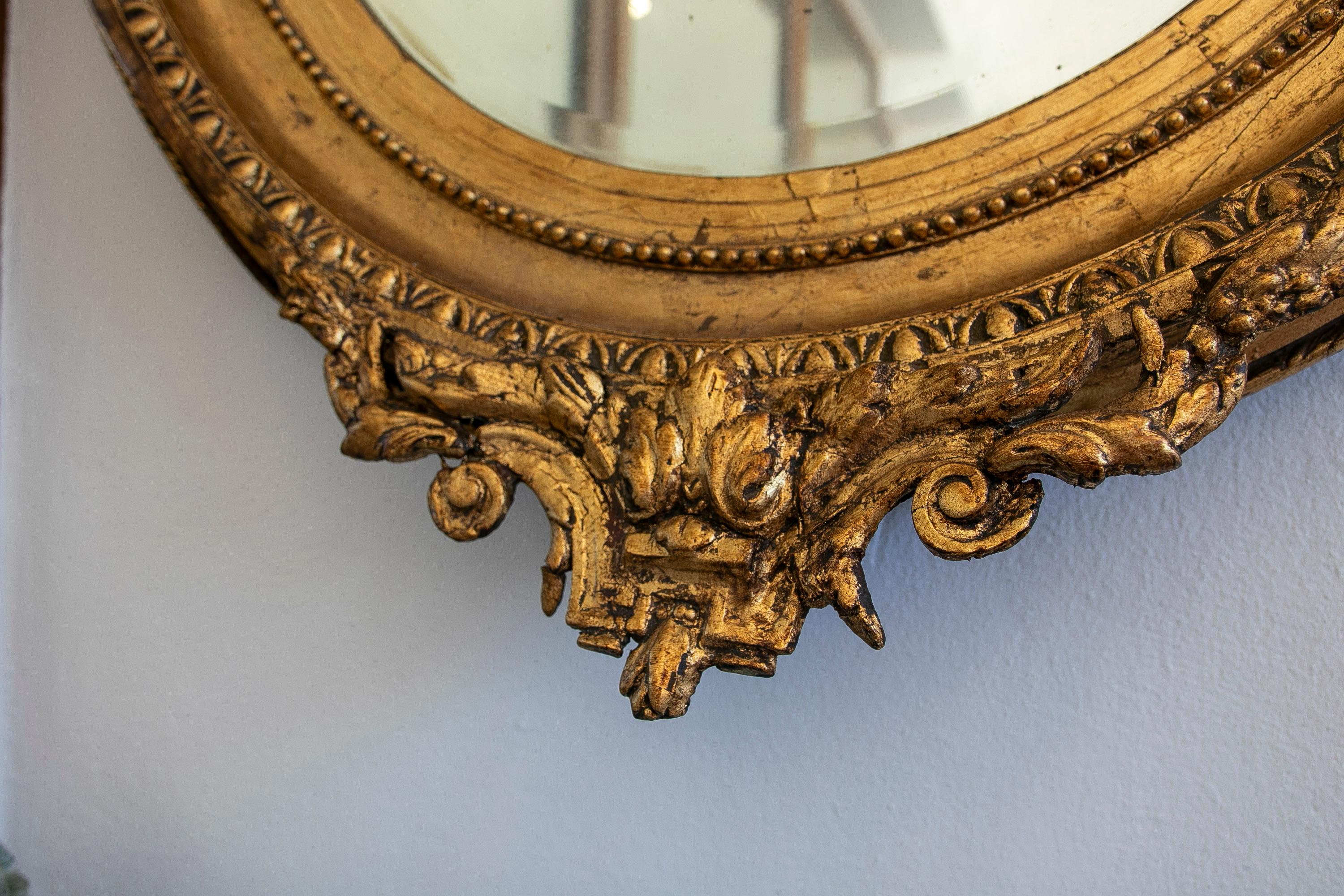 Wood French Oval Mirror with Gold Tones and Flower Garland Coping For Sale