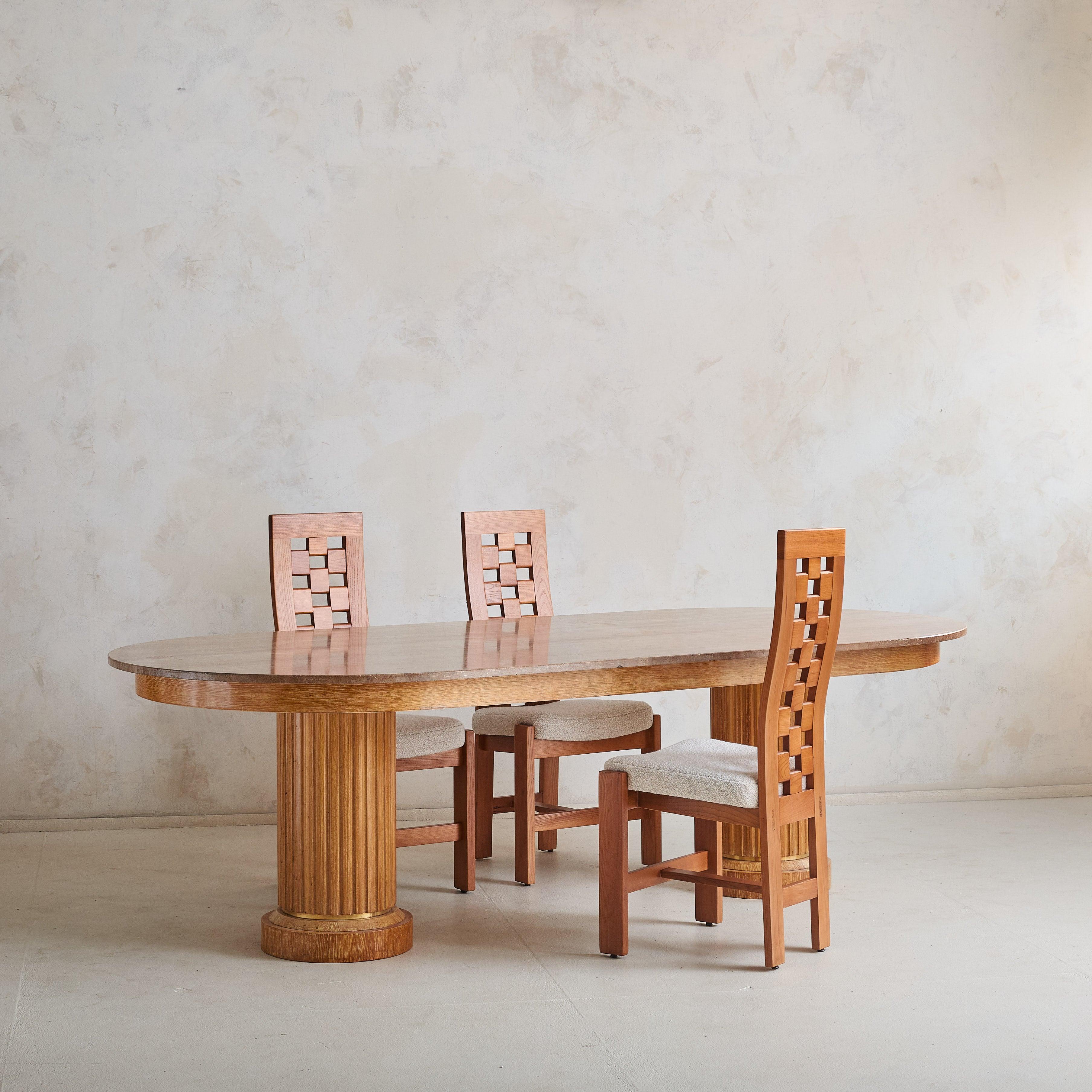 Commissioned for a private residence on the Côte d'Azur in the 1960s, this dining table is defined by elegant proportions and luxurious materials. Crafted from solid oak, its fluted column legs pay homage to classical architecture while providing a