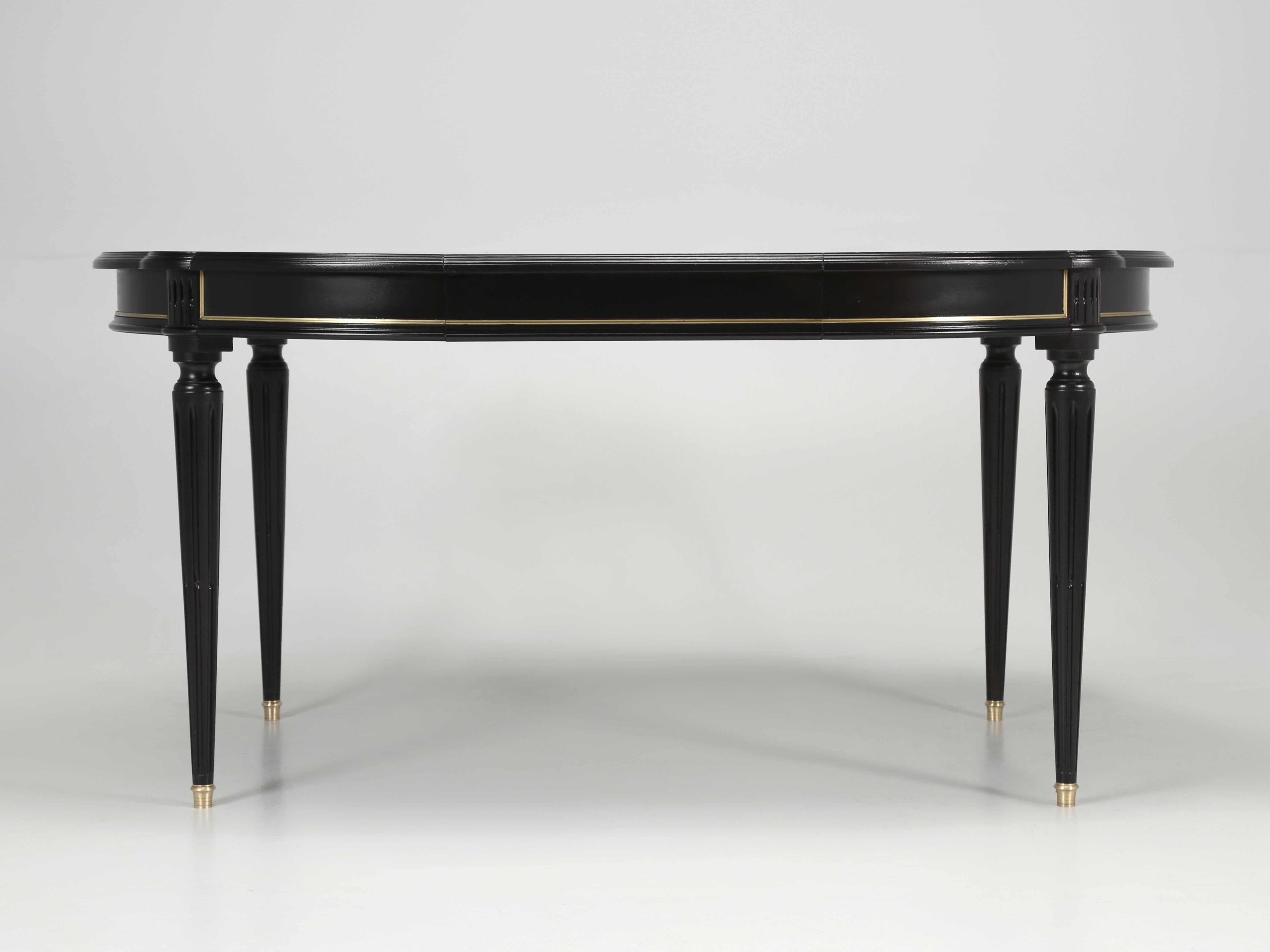 French Louis XVI style dining table, with one-removable matching leaf. The Louis XVI style dining table is constructed from mahogany and our Old Plank finishing department just treated the Louis XVI table to an old school ebonized finish, which
