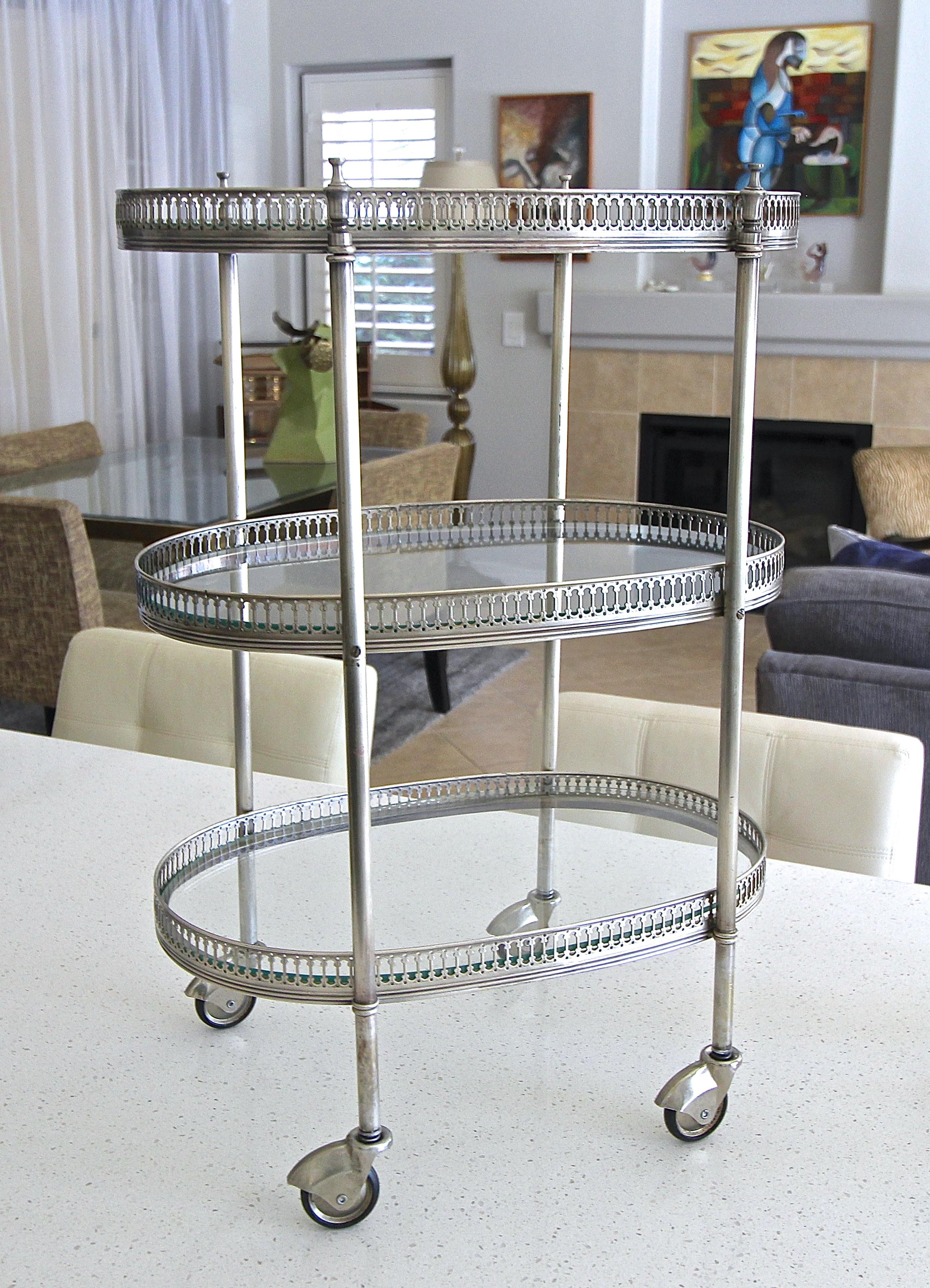 French oval three-tier silver plated smaller scale bar cart, with inset glass shelves and caster wheels. Can also be used as side or end table. Nice refined details in the delicate gallery.