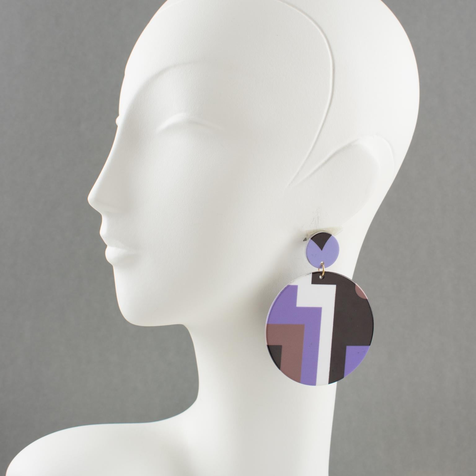 Lovely French oversized resin pierced earrings. Large dangling round flat disc shape with Art-Deco-inspired pattern in assorted colors of purple, taupe, black, and white. For pierced ears. No visible maker's mark.
Measurements: 3.19 in. long (8 cm)