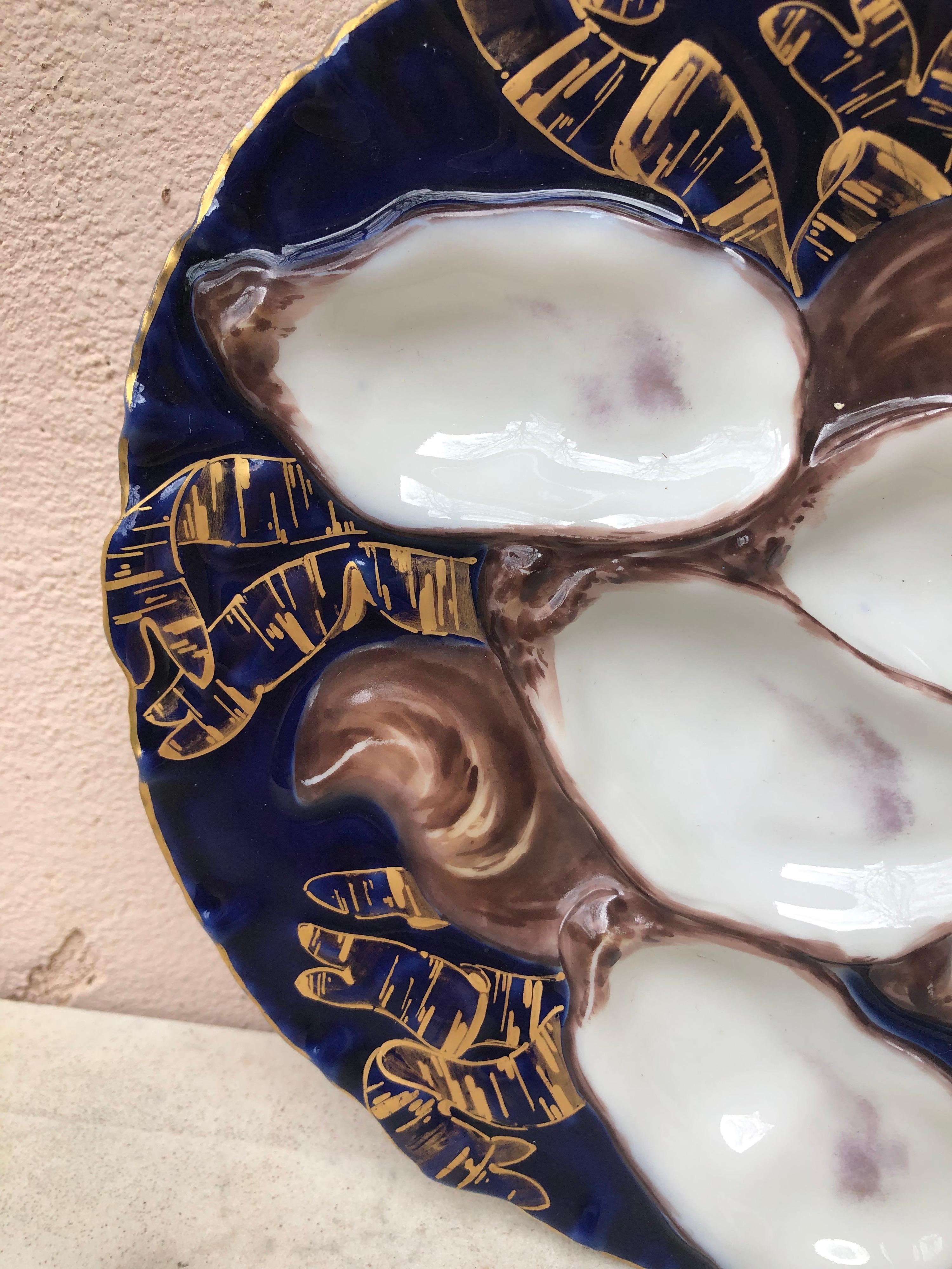 Antique 19th-century French porcelain oyster plate with turkey pattern signed Limoges Haviland.