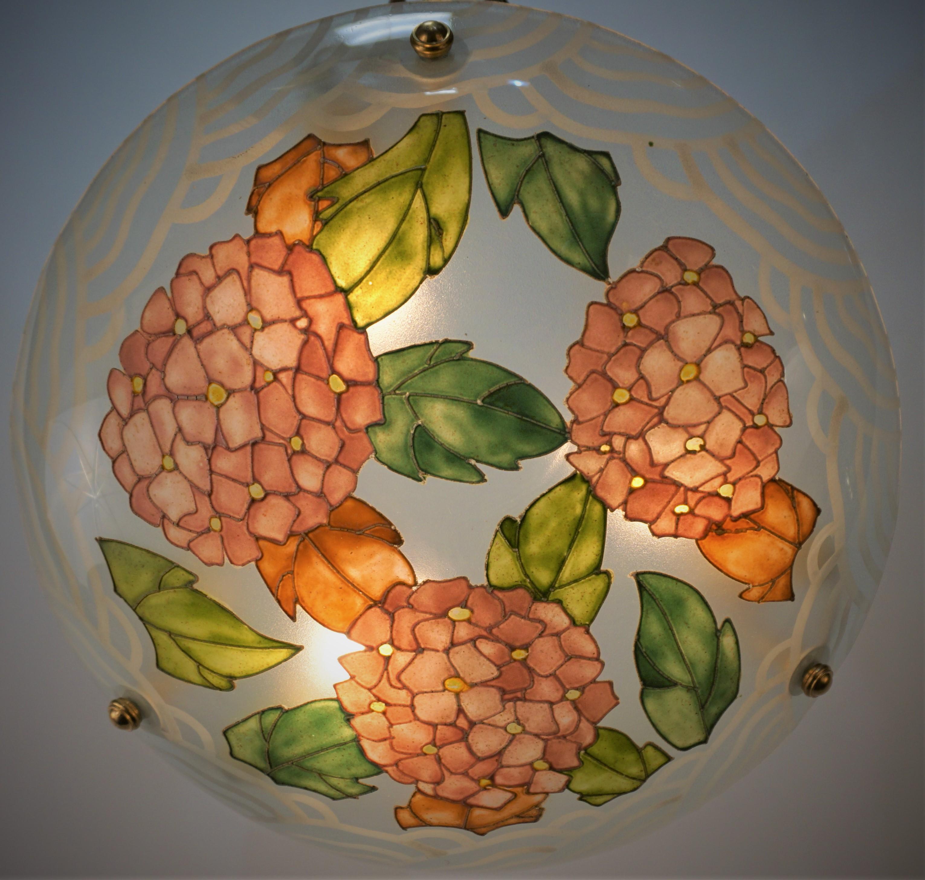 Heavy enameled geometric Hydrangea floral leaf pattern design painted over glass 1920's chandelier with handmade press brass chain and canopy.
Three lights 75watts max each.