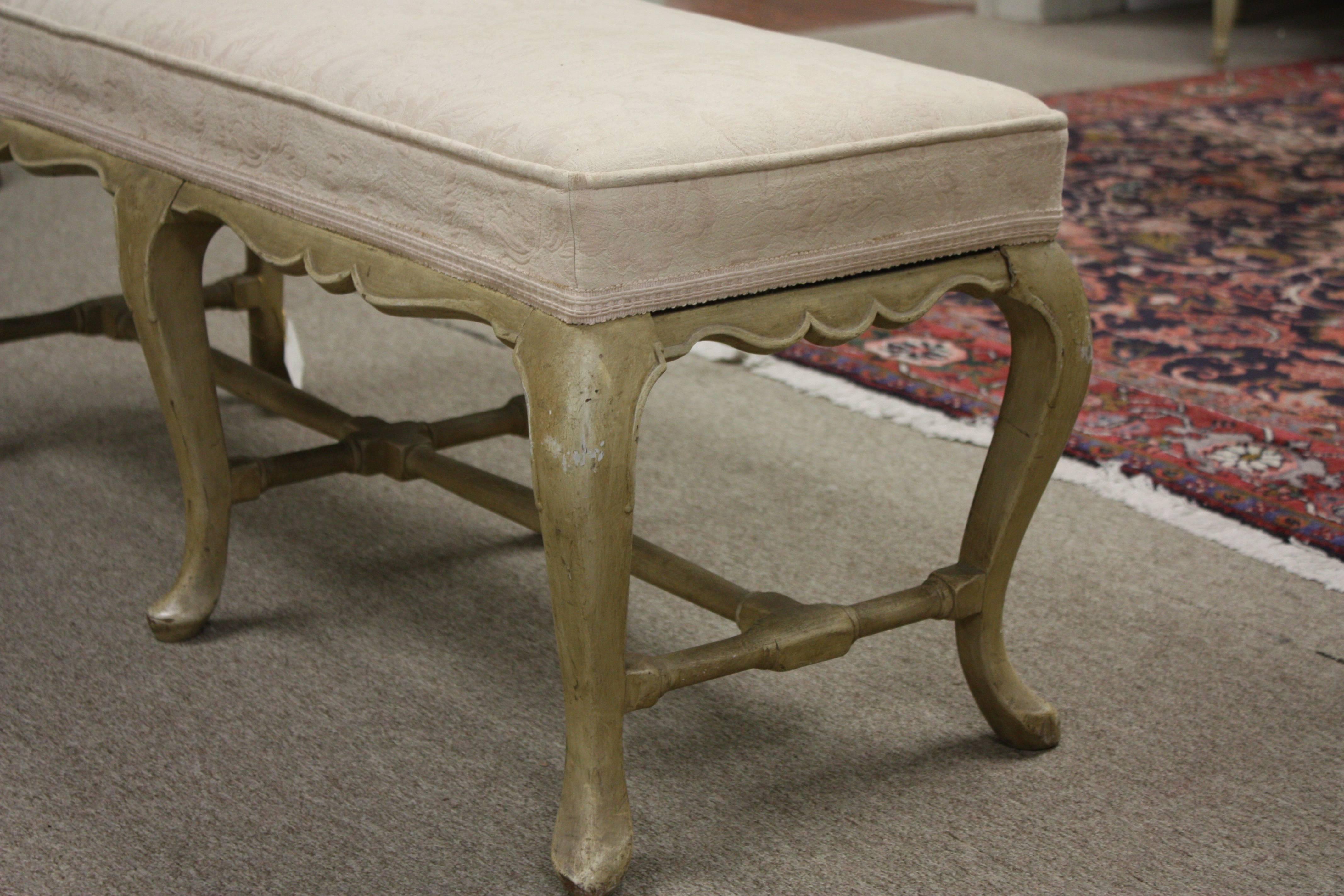 This attractive bench features the beautiful cabriole legs joined by stretchers that appeared during the early 18th century. Beautifully painted in a natural cream and simple lines makes this bench suitable for any decor.