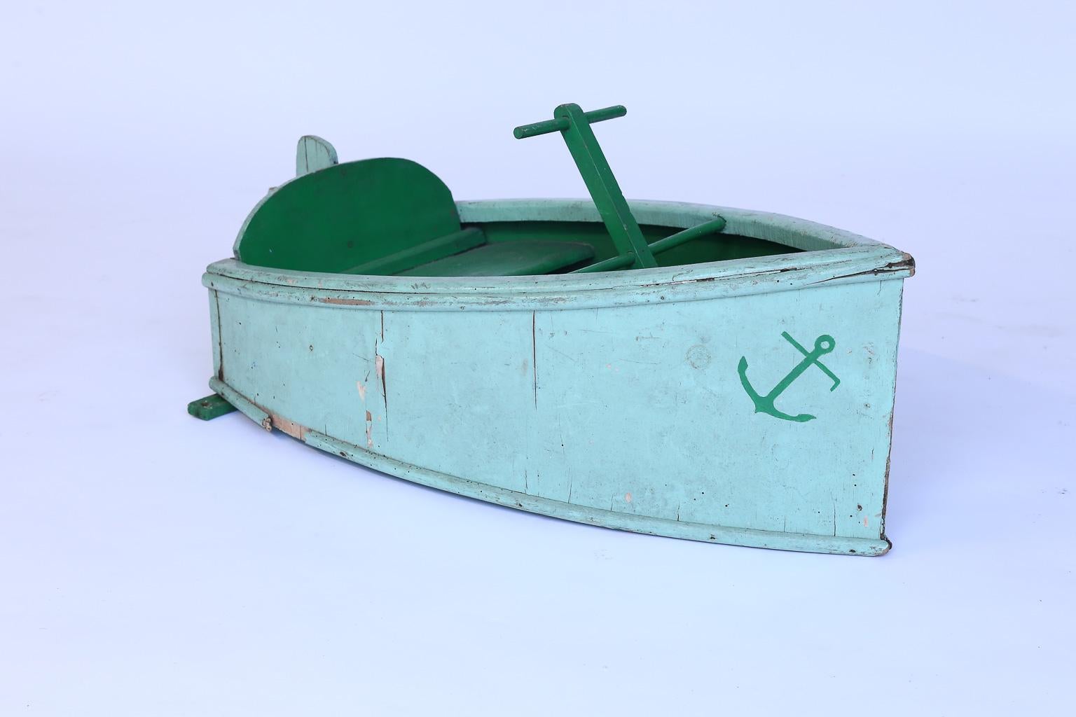 Found in the South of France this painted boat from a children's carousel ride is absolutely adorable. The piece has its original green paint and would be lovely in a beach, lake or nursery setting.