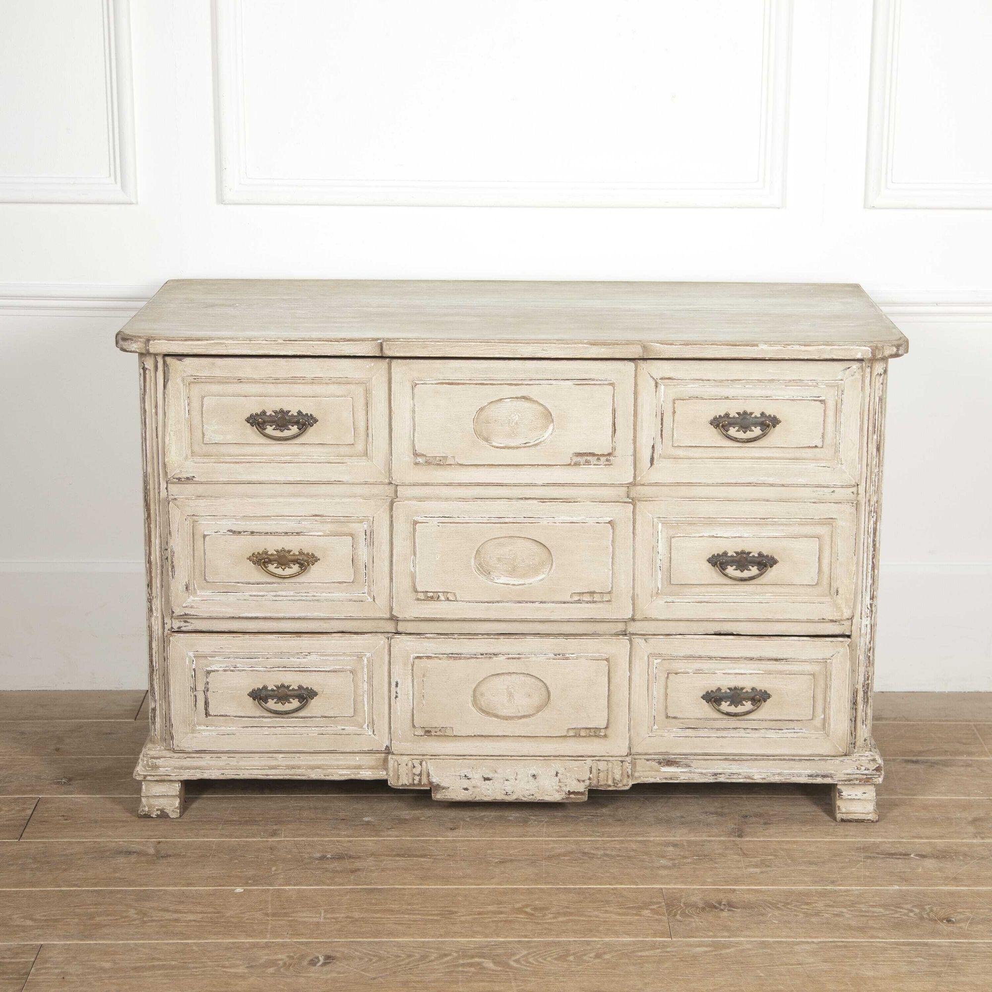 French 19th century painted breakfront commode.
This pretty chest features three long drawers with decorative metal handles to each end and unusual carved ovals to the central breakfront section. 
The sides are reeded and the piece is finished