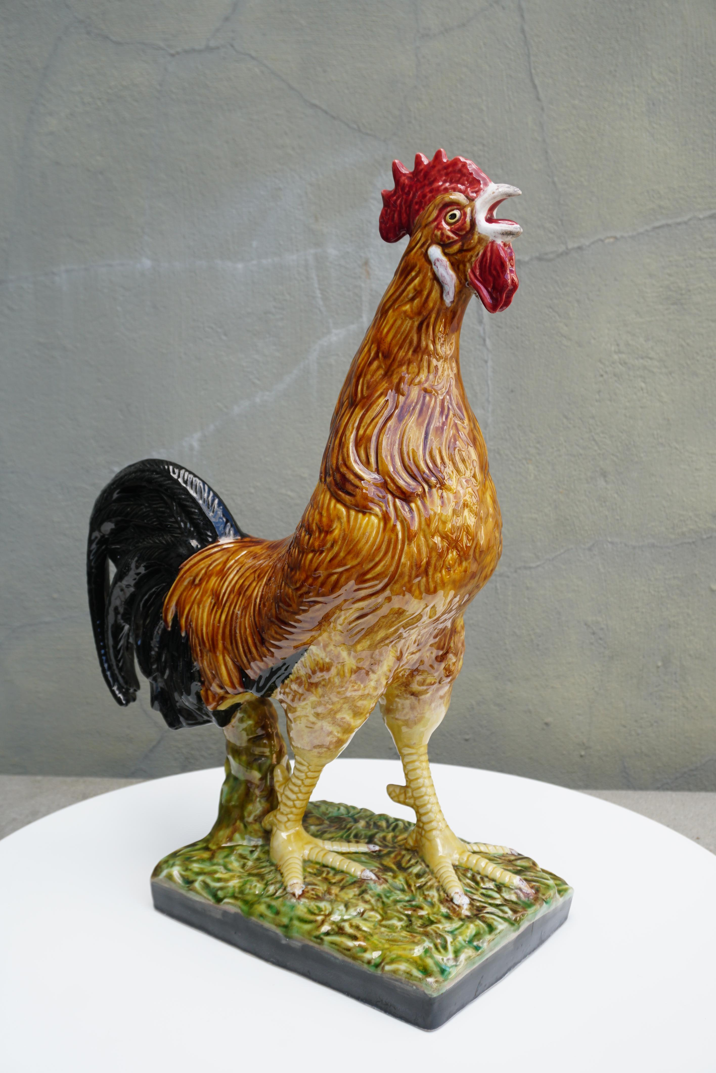 Add the charm of the French countryside to your home with this large, colorful and rare ceramic rooster sculpture. Crafted in France circa 1960 in the style of Paul Comolera or Louis Carrier Belleuse. The elegant barbotine sculpture is hand painted