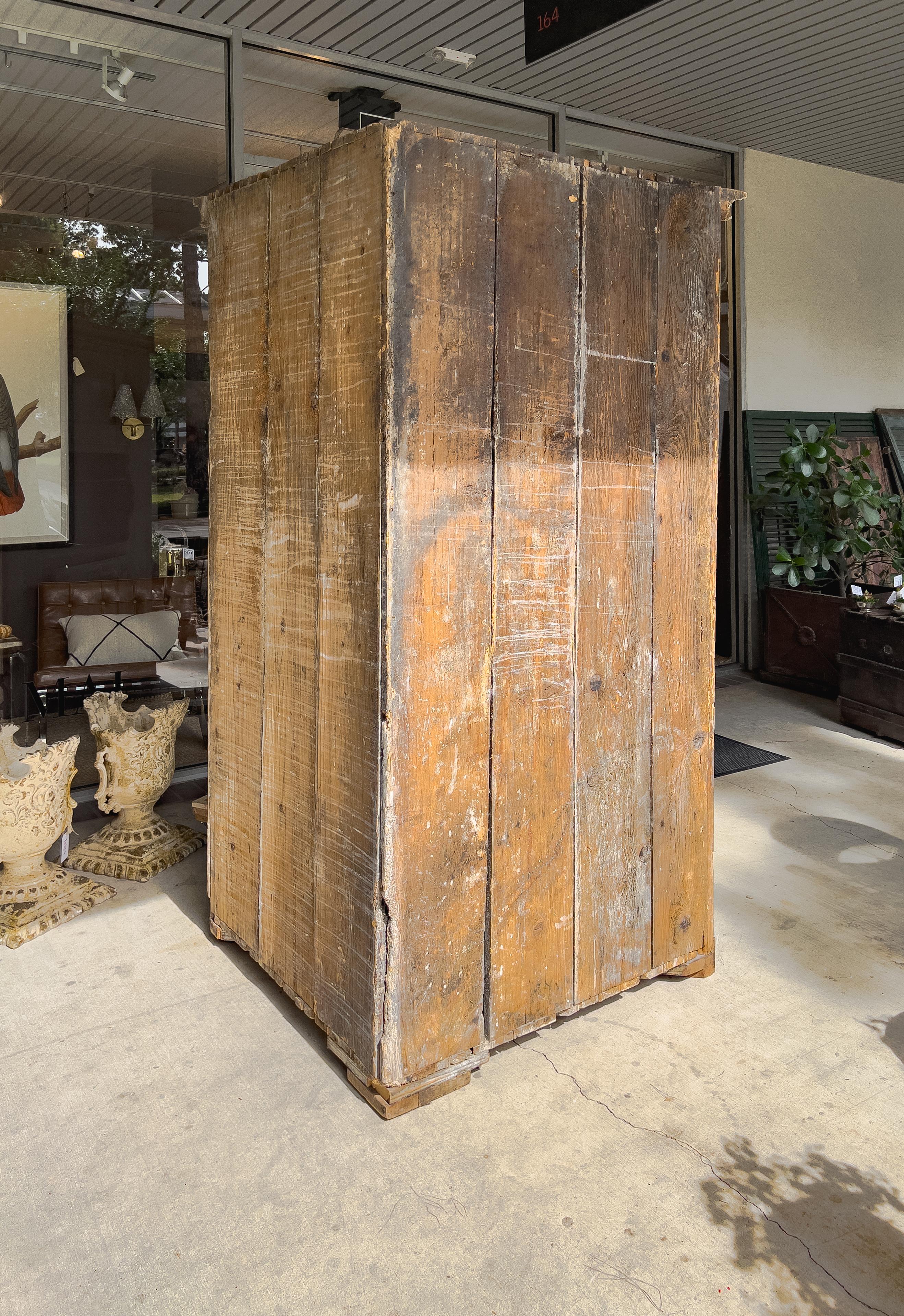 Swedish painted corner cabinet on a plinth base with two block panel doors and a shaped open display in the middle of the piece.  Inside each door there is an interior shelf and the open display in the middle has a shallow shelf that runs against