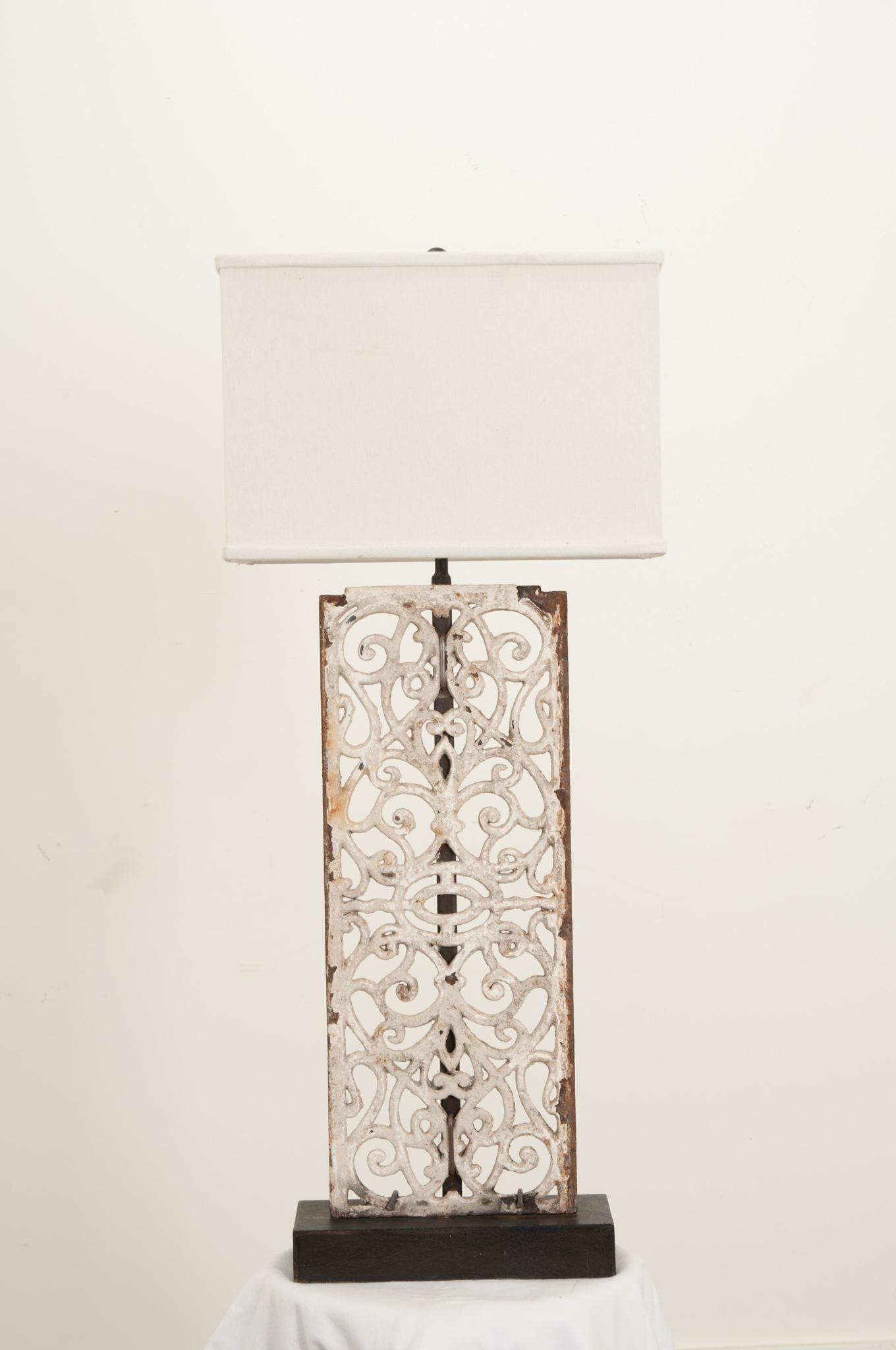 This newly made table lamp from a vintage painted iron panel is a great way to add tons of character to your interior. Painted white and perfectly patinated, the panel is securely fixed to the black metal base and center support. The rectangular