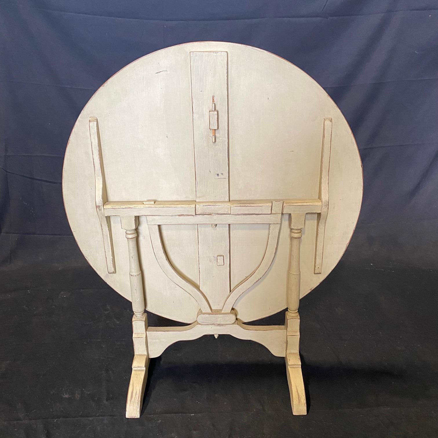 Versatile tilt top French vintage wine tasting table.  Great as a side table or small dining table.  This one is painted an antiqued white.
Apron 25.75 h
Closed with top in upright position  42.25 H 16.5 D
#3060

