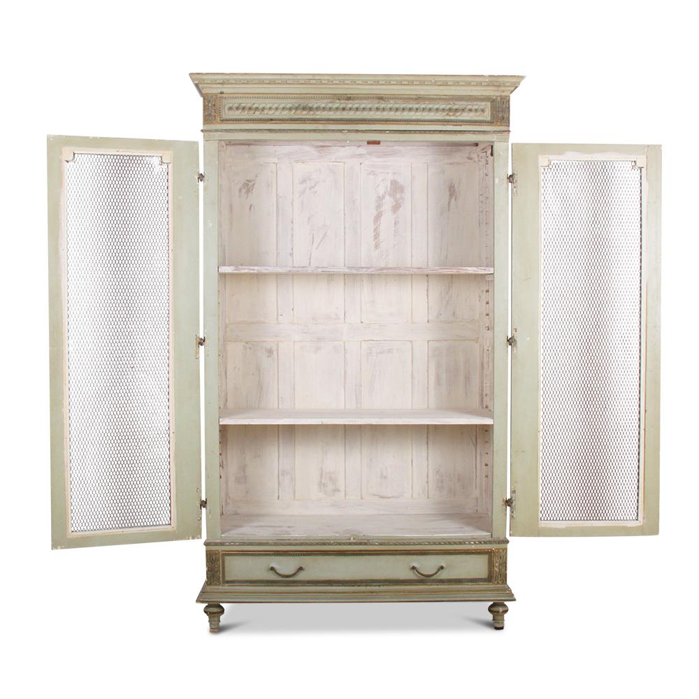 A painted and gilt French Louis XVI style two-door bookcase with gilt mesh doors and a single drawer below