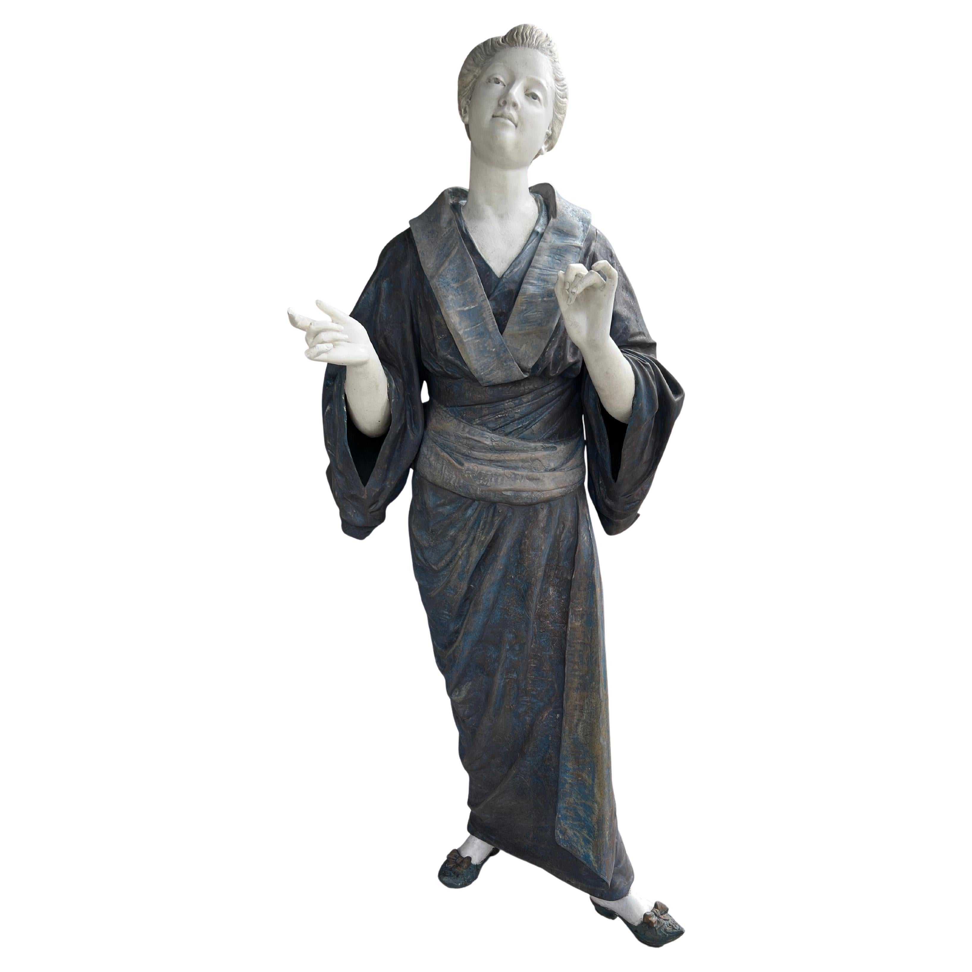 Figure standing wearing kimono with arms out front. On an iron base. Signed Ch Masse , Sculp, Paris. Provenance , Estate Of William Hodgins. Interior designer. Boston Ma.