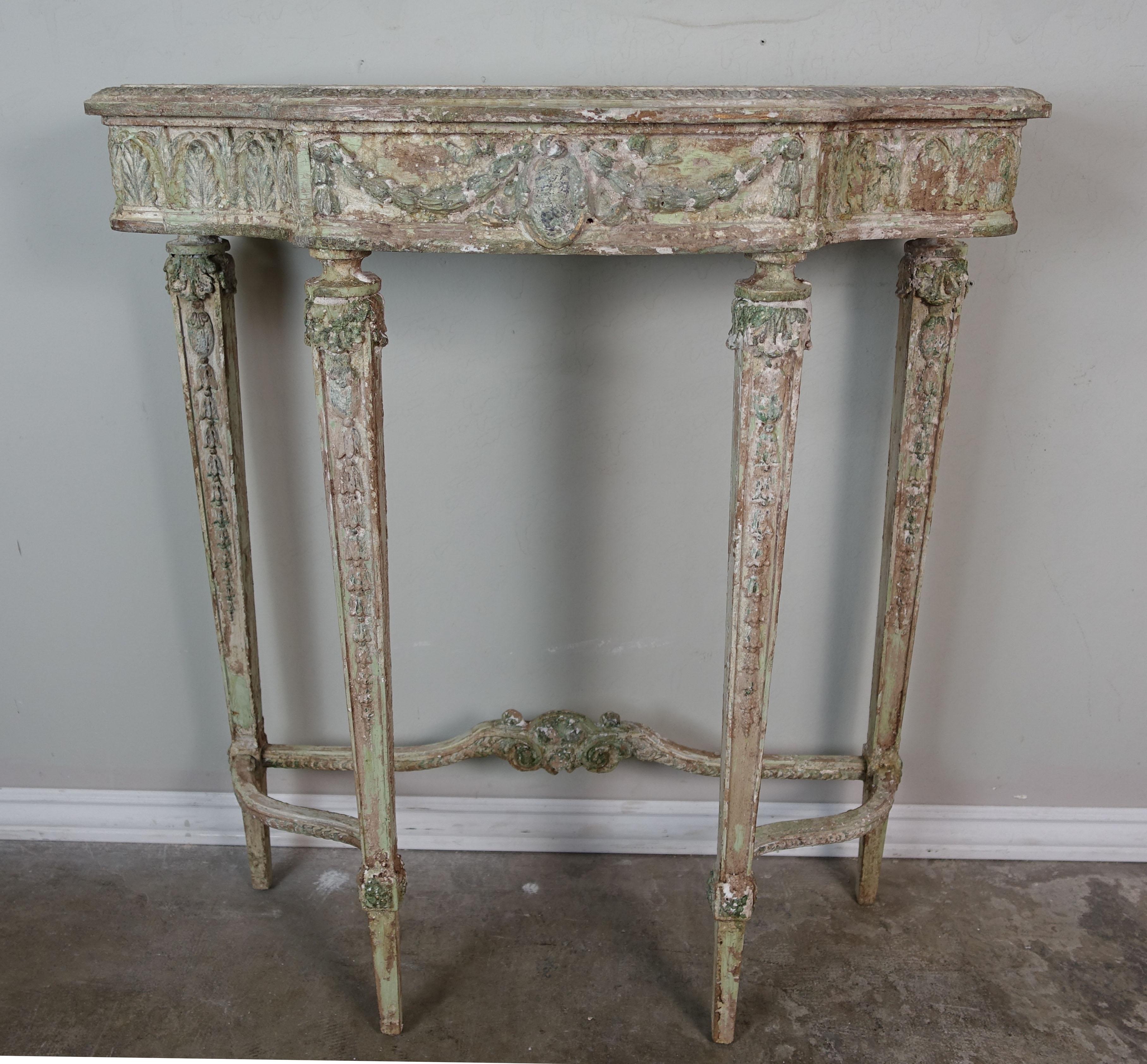 French painted neoclassical style console in a worn, distressed finish. The mirror is Rococo style with carved roses and acanthus leaves throughout in a similar worn, distressed finish.
Mirror measures 17