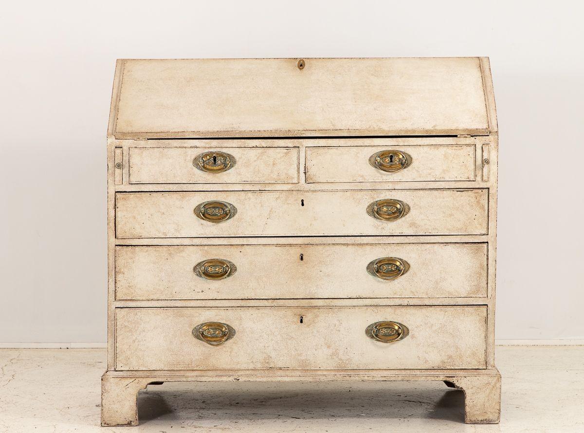 This stunning Mid-19th-century French Painted Secretary Desk has a captivating fall-front design. This piece showcases an elegant white exterior paint that exudes timeless sophistication, while the interior surprises with a delightful coral paint,